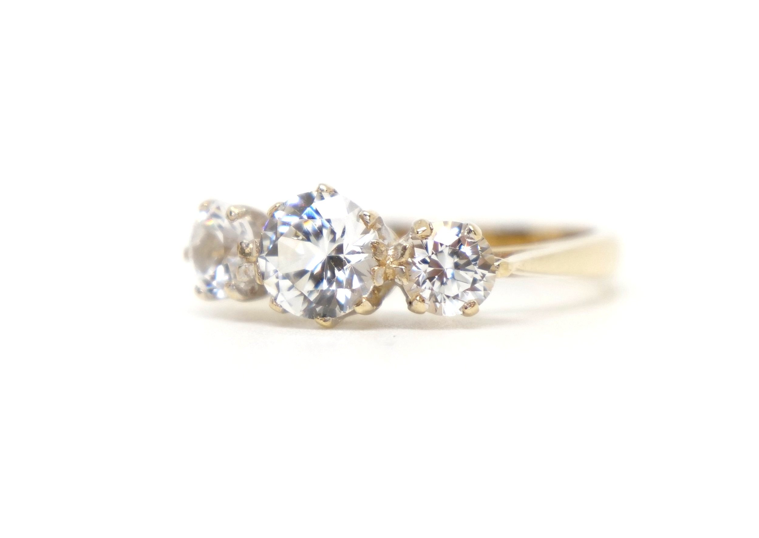 Lovely vintage 9ct gold trilogy ring in fantastic condition. The ring is set with three white spinel stones, with an overall carat weight of approximately 2cts.