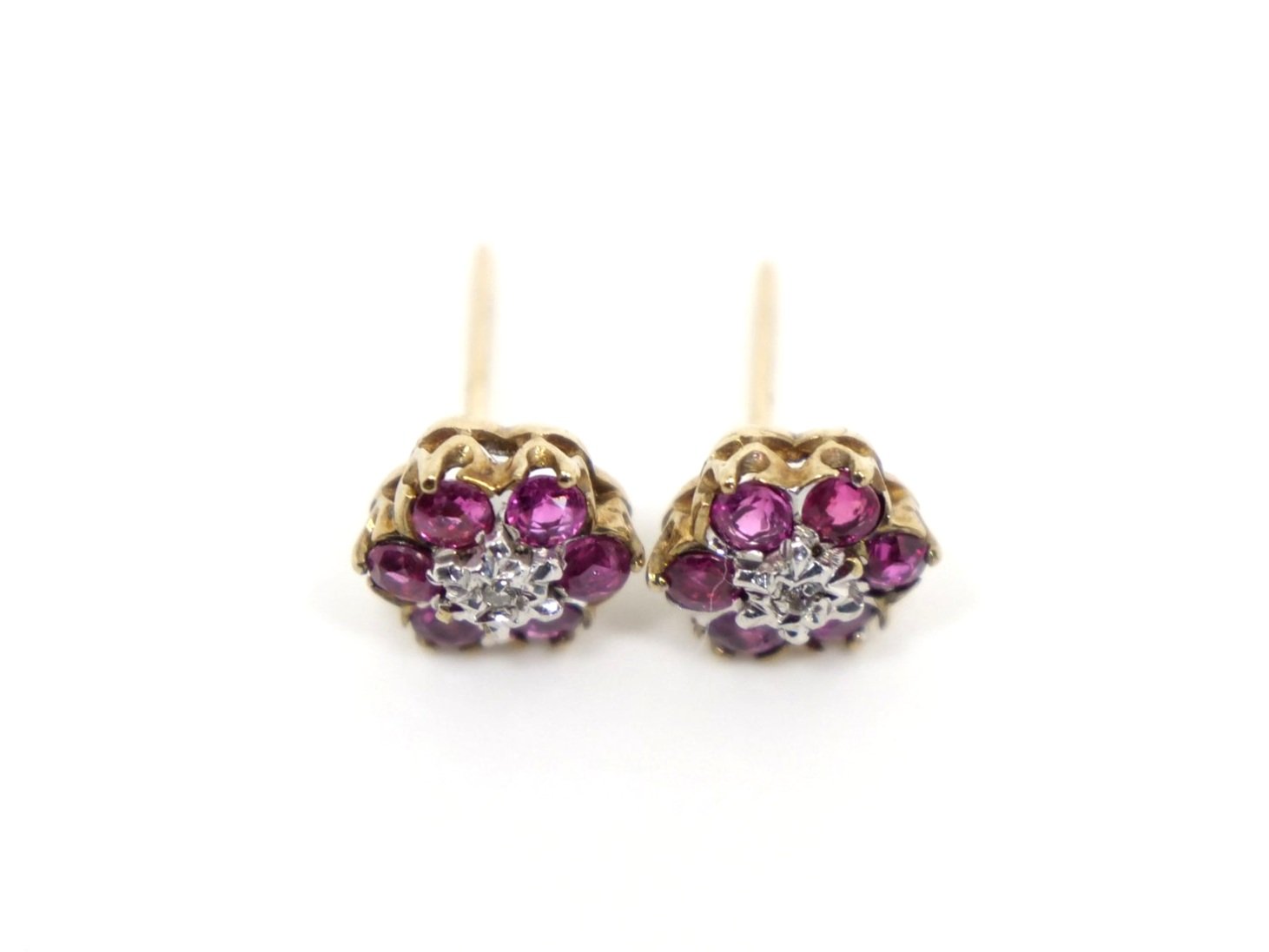 Beautiful ruby and diamond flower earrings in 9ct gold, each set with six round cut rubies and a single central diamond.