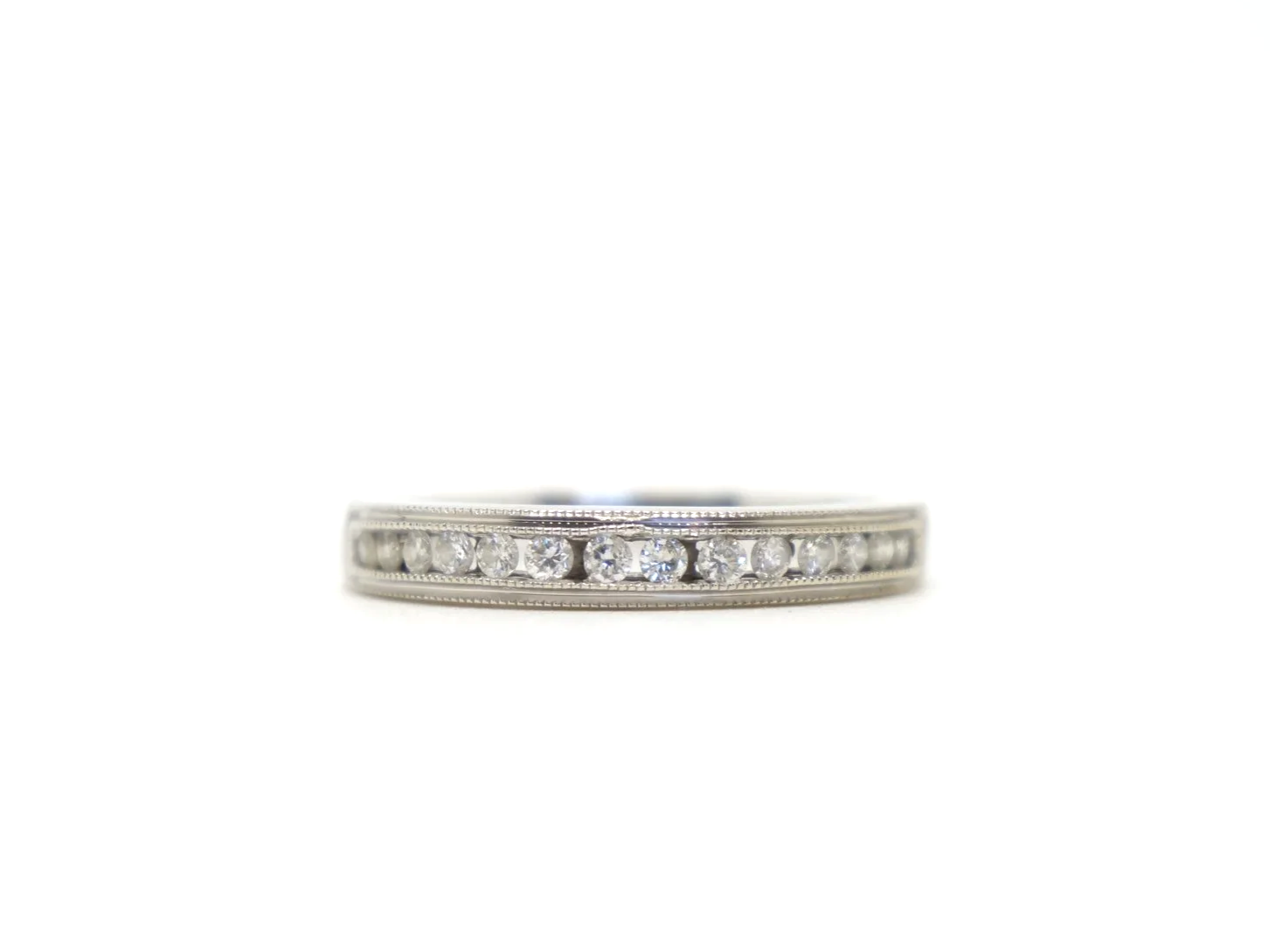 Beautiful 18ct white gold diamond half eternity ring, channel set with a row of brilliant cut diamonds across the front of the band, totalling 0.25ct.