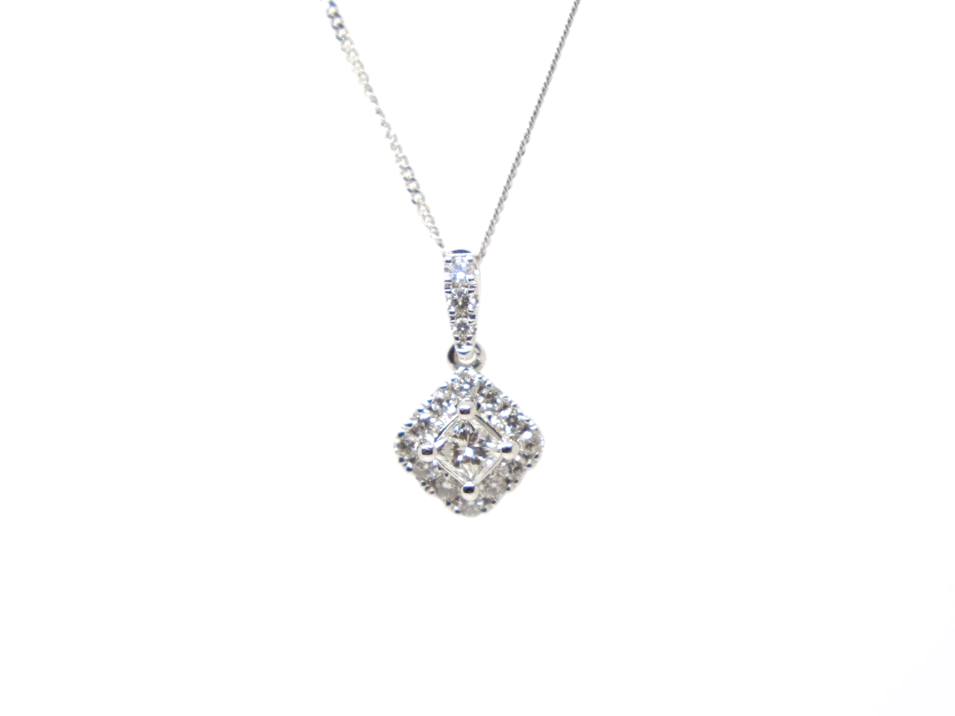 Very pretty 9ct white gold pendant set with a central princess cut diamond, framed by a cluster of brilliant cut diamonds to form a soft diamond shape.