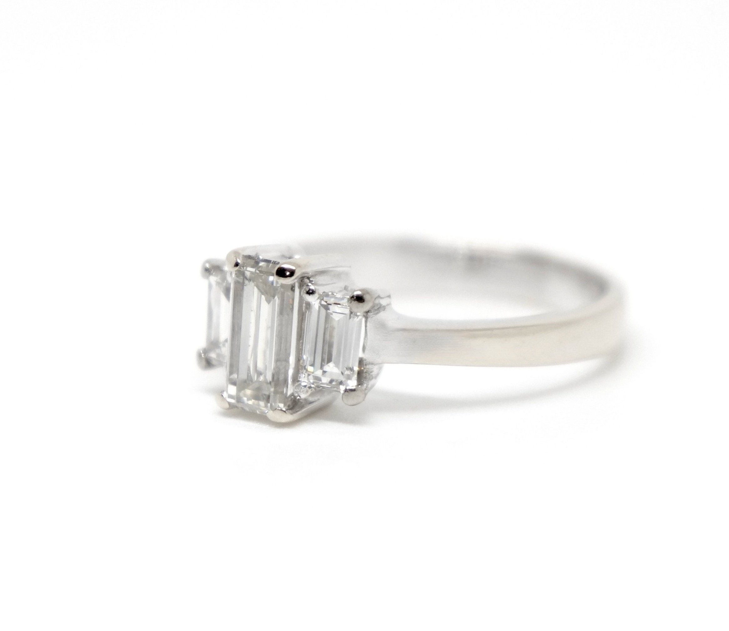 Unusual 18ct gold diamond three stone ring, set with three baguette cut diamonds in this classic and elegant design. Approximately 0.85cts total diamonds.
