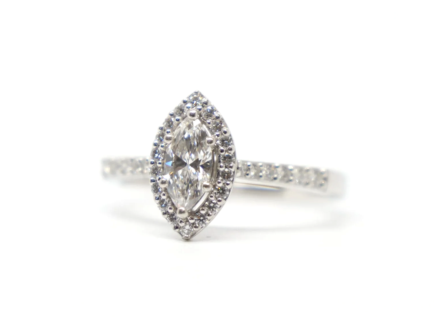platinum diamond halo ring set with a marquise-cut diamond at the centre, surrounded by a pavé-set halo