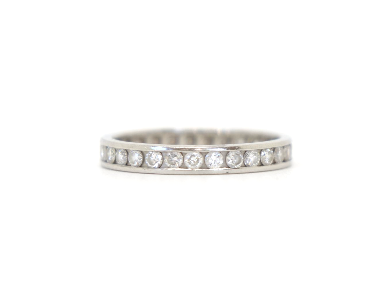 Contemporary platinum diamond full eternity ring, set with approximately 1ct brilliant cut diamonds.