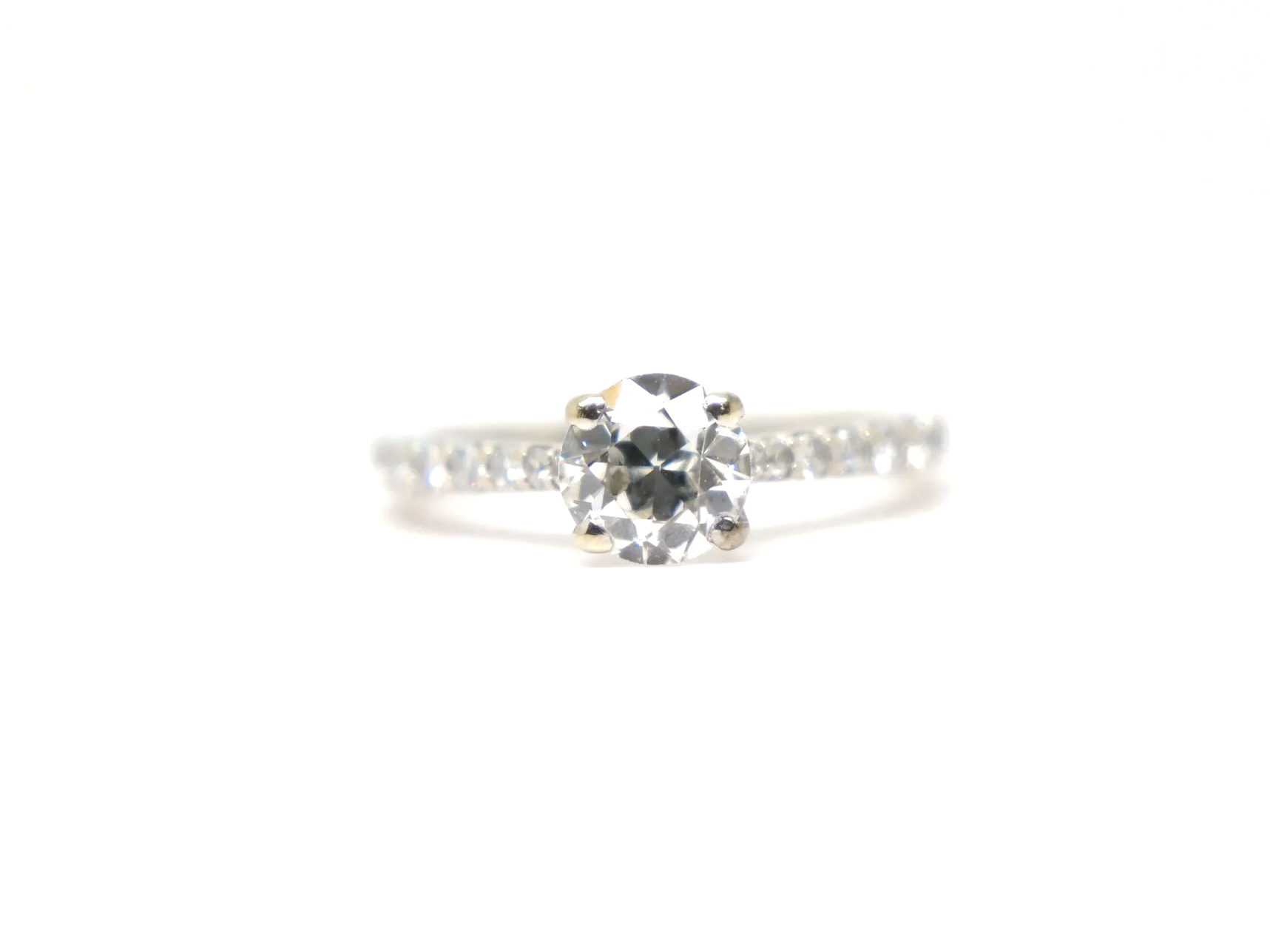 An 18ct gold old cut diamond solitaire with diamond-set shoulders