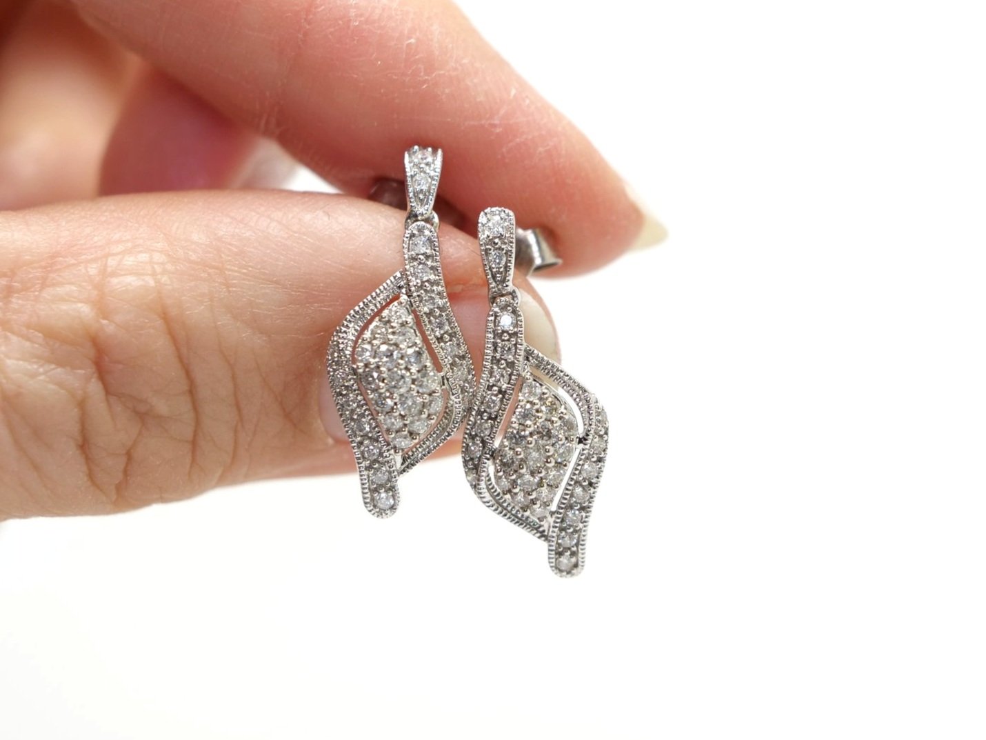 Lovely 9ct gold diamond drop earrings, each set with 0.25ct diamonds set into this unusual shape, with milgrain edging.