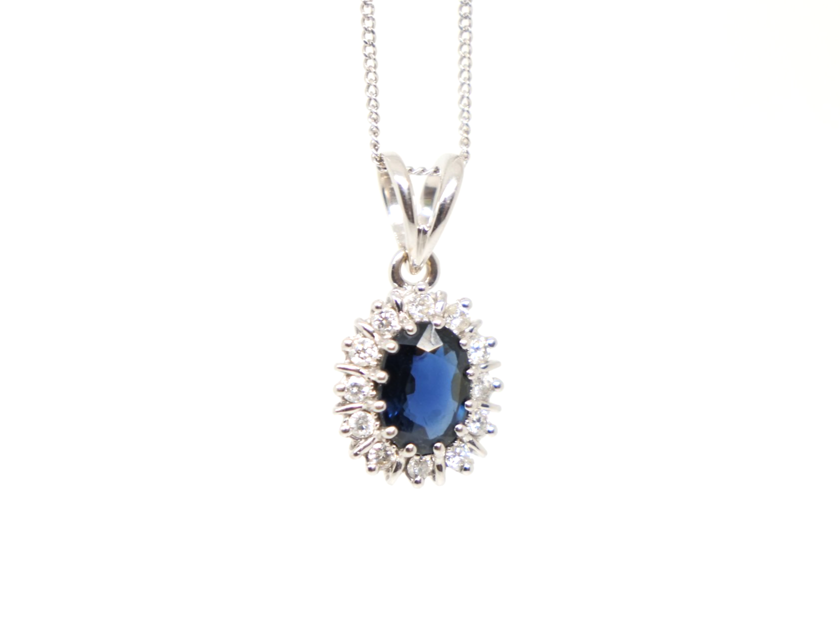 Lovely 18ct gold preloved sapphire and diamond pendant and chain, set with an approximately 1ct sapphire and surrounded by diamonds.