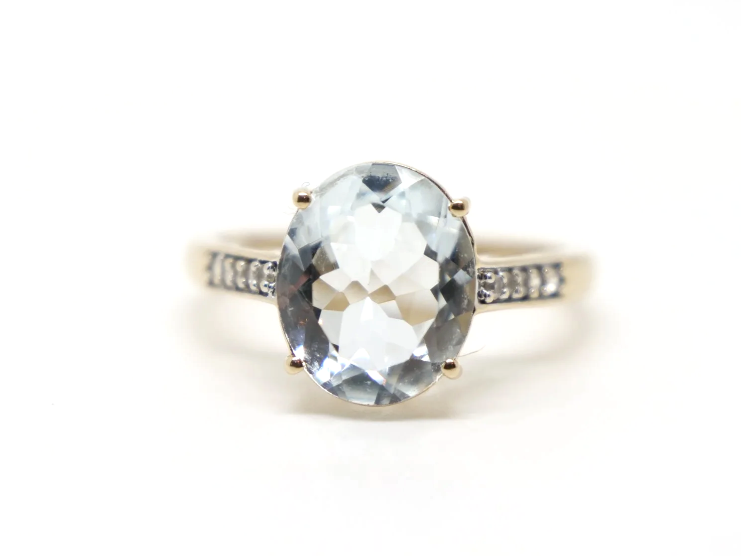 Lovely 10ct gold aquamarine and diamond cocktail ring, set with a large oval cut aquamarine with small diamonds to each shoulder.