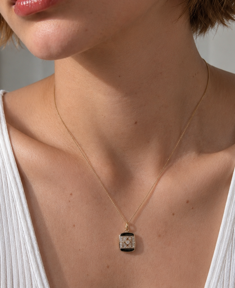 Art Deco onyx and diamond pendant, set in platinum and 18ct gold.png