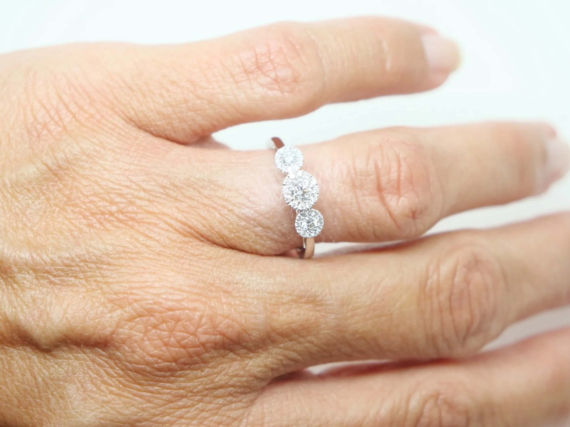 Contemporary 18ct gold diamond ring in a very pretty triple halo three stone design. Approximately 0.5cts diamonds total.