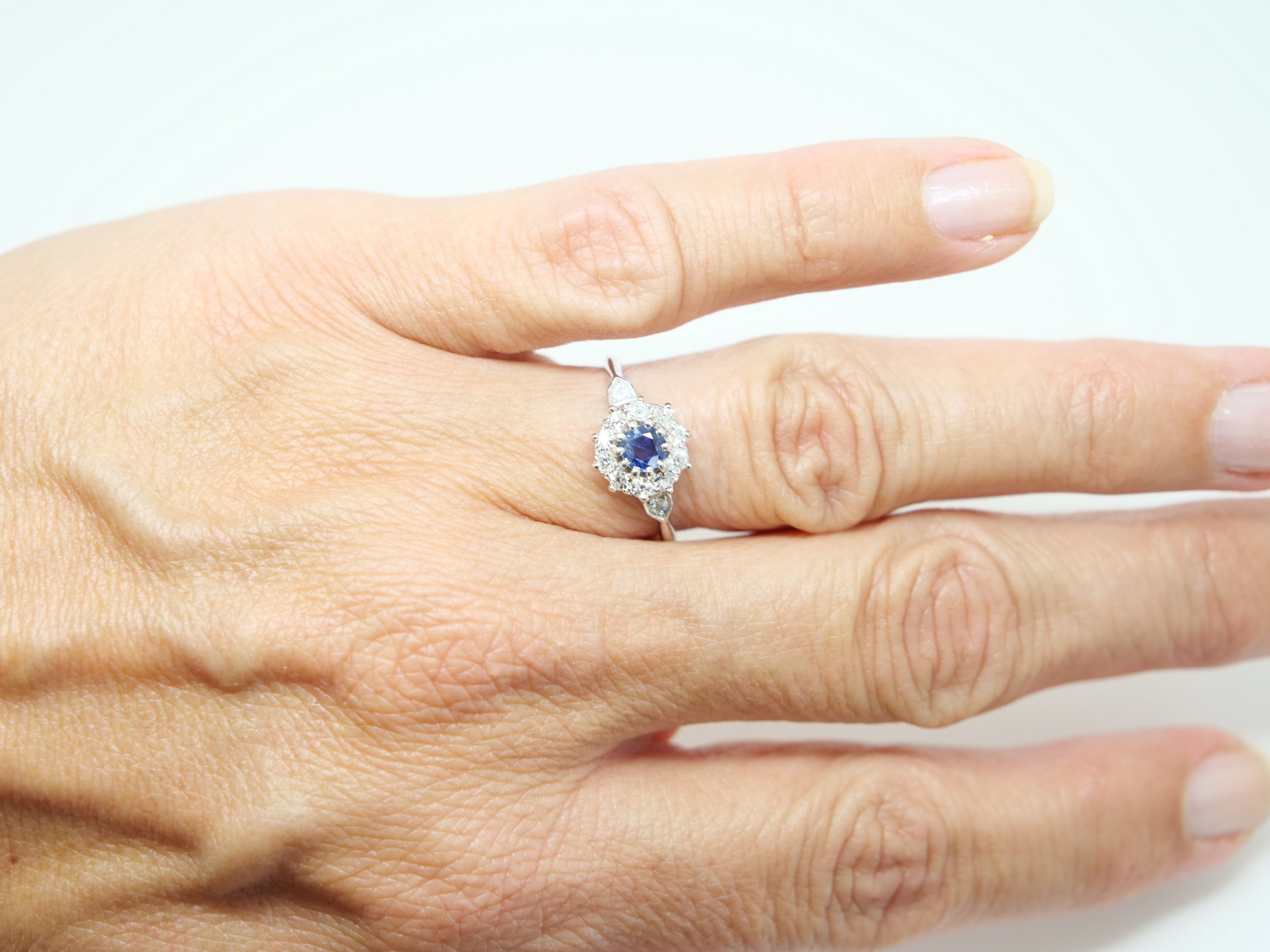 18ct gold sapphire and old cut diamond cluster ring, central blue sapphire with a halo of old cut diamonds, UK size N