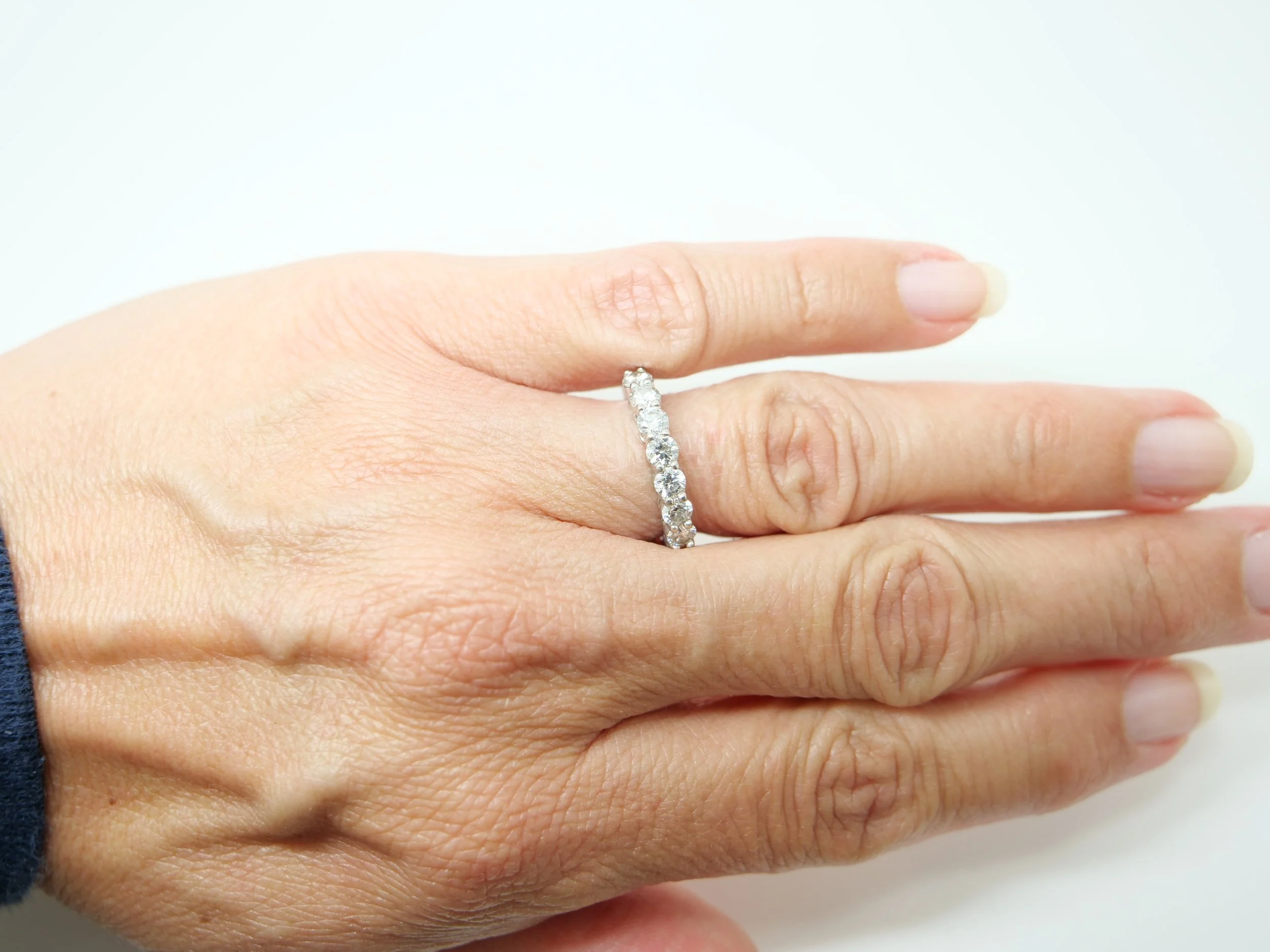 platinum diamond half-eternity ring set with seven round brilliant-cut diamonds