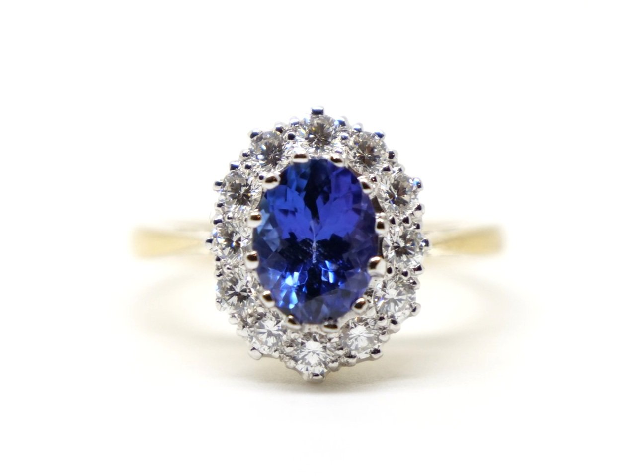 Unusual vintage 18ct gold superb tanzanite and diamond cluster ring, set with a beautiful oval cut violet tanzanite and surrounded by diamonds.