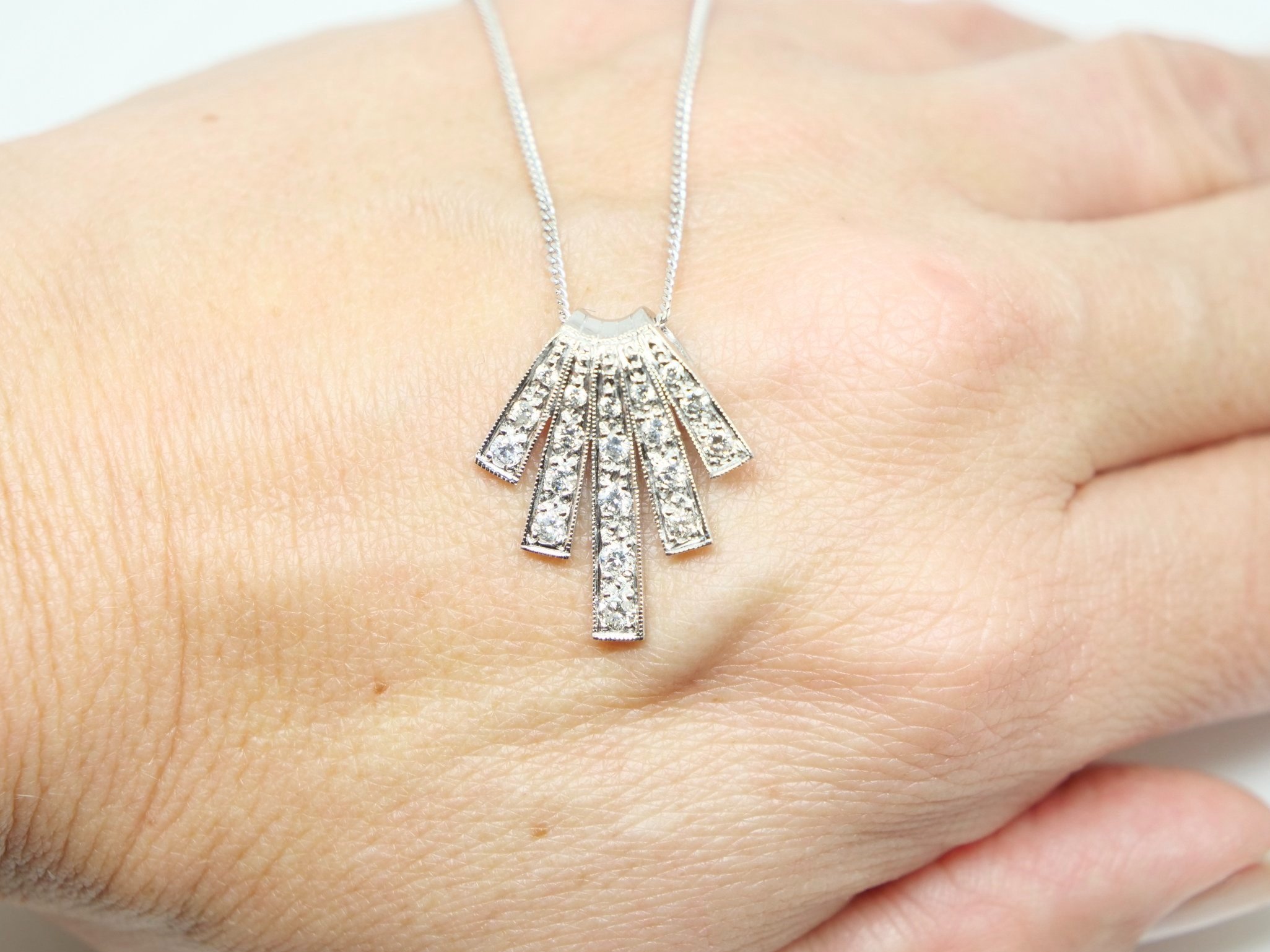 Stunning platinum diamond pendant in this wonderful Art Deco design. Approximately 0.7ct diamonds. With 18ct gold 18” chain.