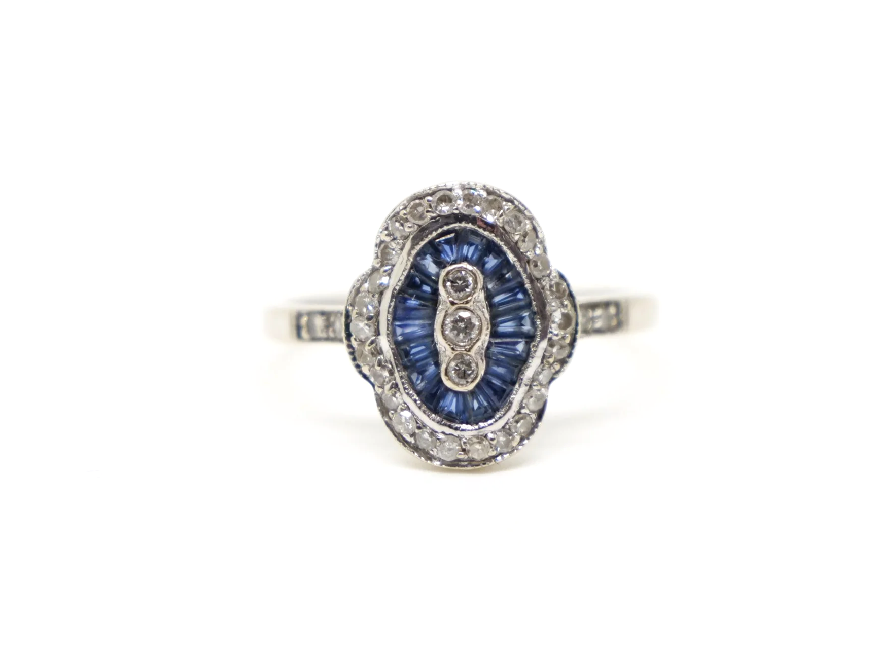 Unusual 18ct gold sapphire and diamond ring in this lovely Art Deco design. Set with calibre cut sapphires and small diamonds.