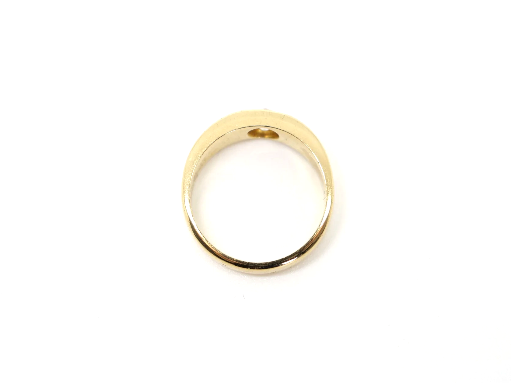 An 18ct gold Victorian gold gypsy ring dating from 1879 featuring a single old mine cut diamond of approximately 0.4 carats.