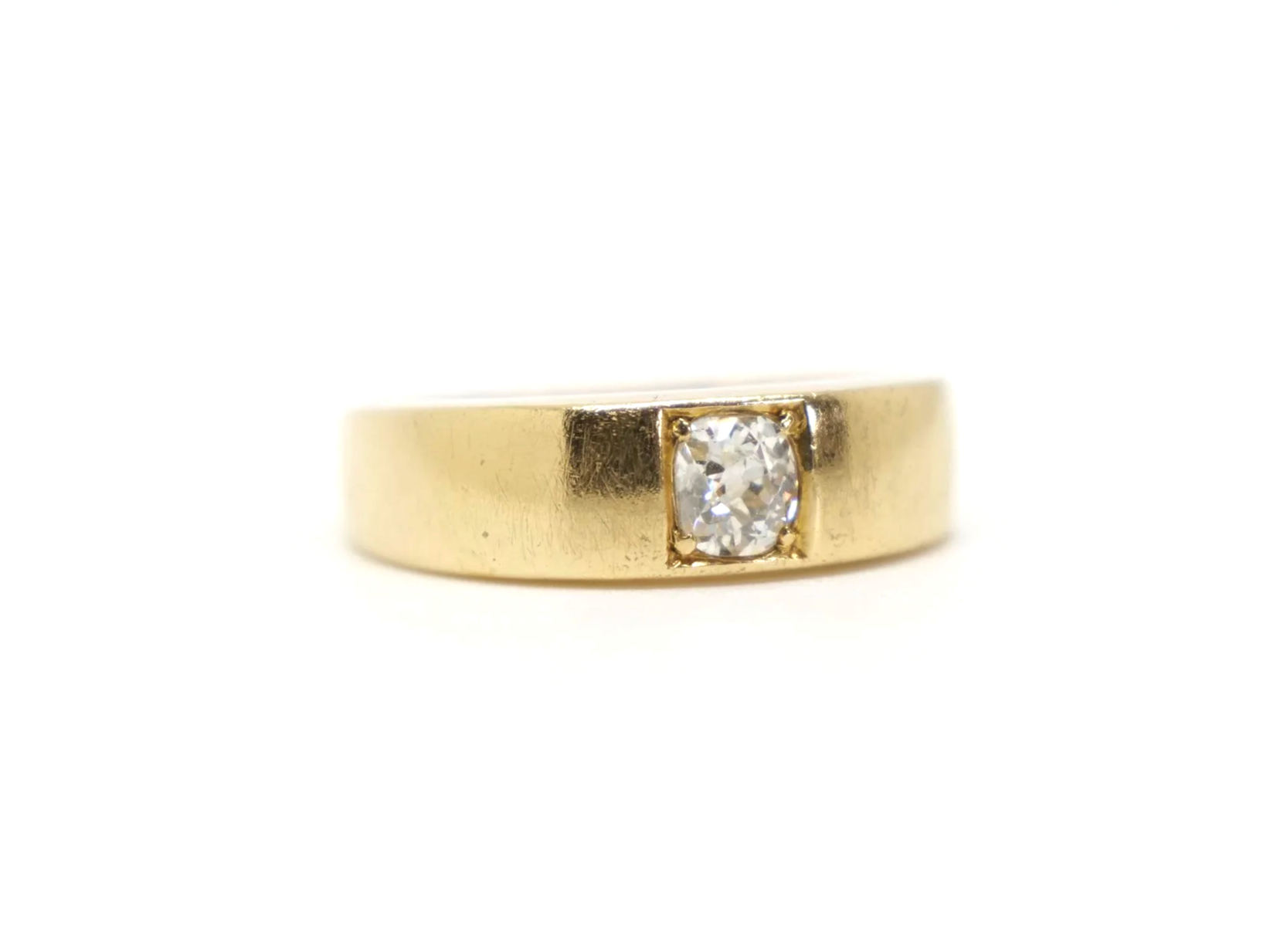 An 18ct gold Victorian gold gypsy ring dating from 1879 featuring a single old mine cut diamond of approximately 0.4 carats.