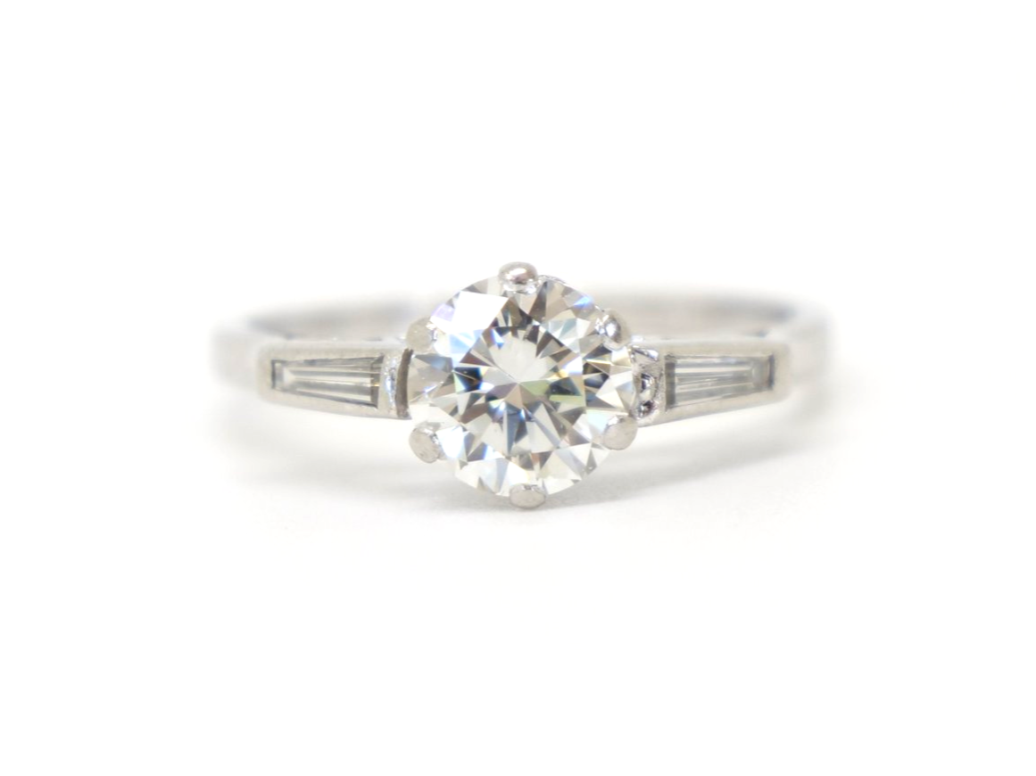 Stunning platinum Art Deco diamond solitaire ring, set with a gorgeous central brilliant cut diamond, with a baguette cut diamond to each side. Approximately 1.25cts total diamonds.