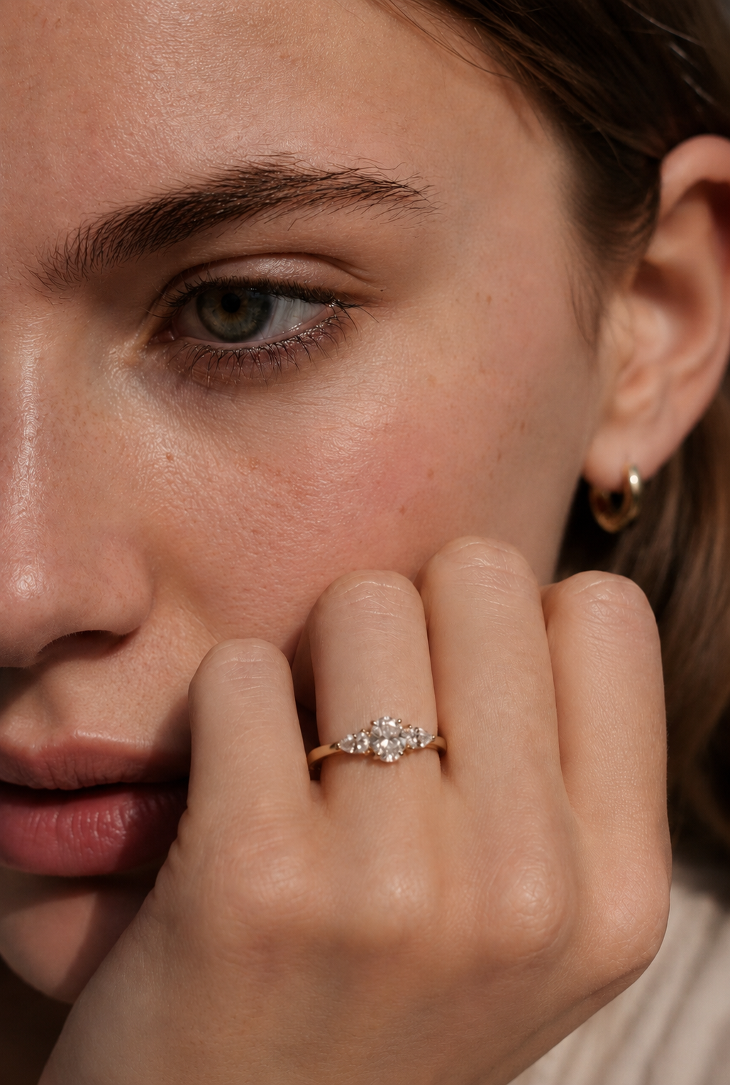 18ct yellow gold three-stone diamond ring, set with an oval brilliant-cut diamond at the centre, with a pear-cut diamond to each side