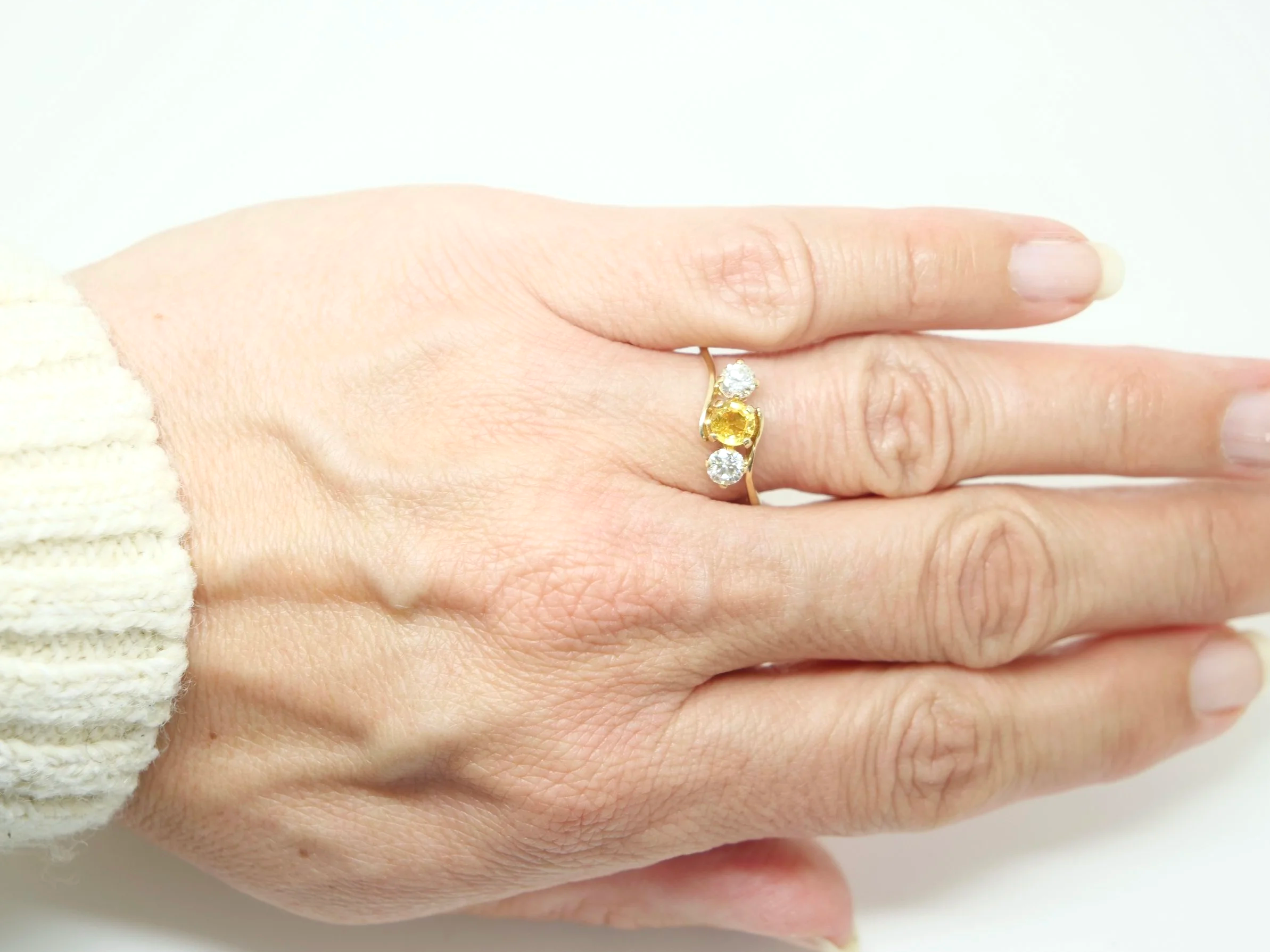 Lovely 14ct gold vintage twist design ring set with a yellow sapphire and two brilliant cut diamonds.