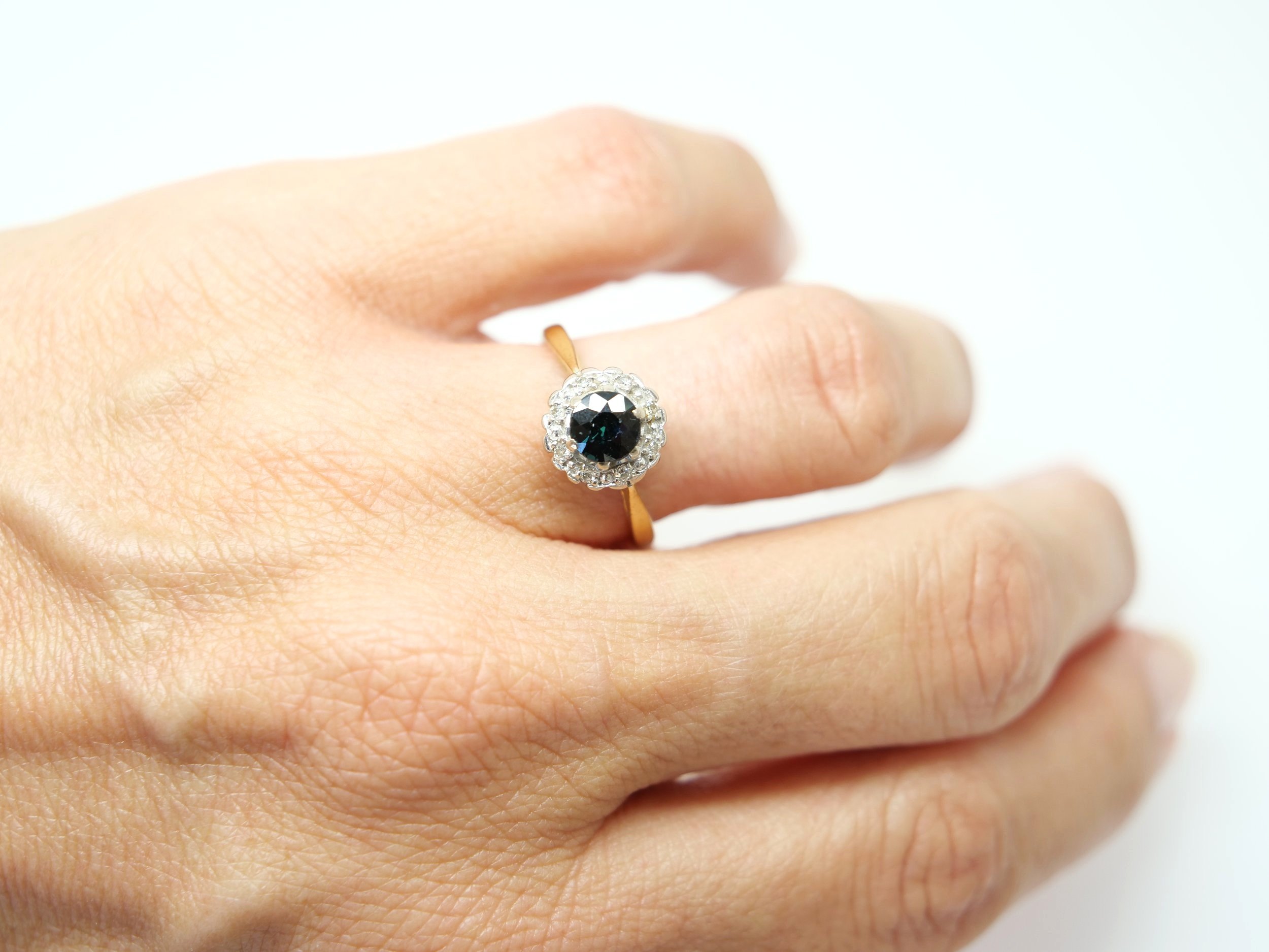 Classic vintage 18ct gold sapphire and diamond ring, set with a central, round cut sapphire of approximately 0.75ct and surrounded by diamonds.