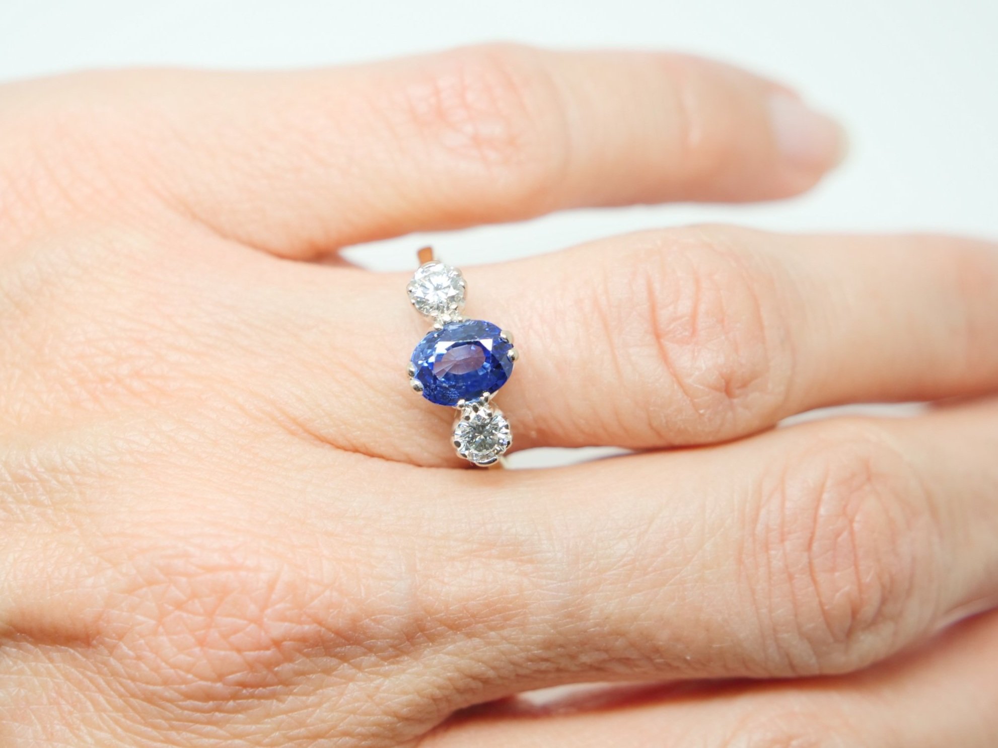 Stunning vintage 18ct gold sapphire and diamond ring, set with an oval cut sapphire with a diamond to each side.