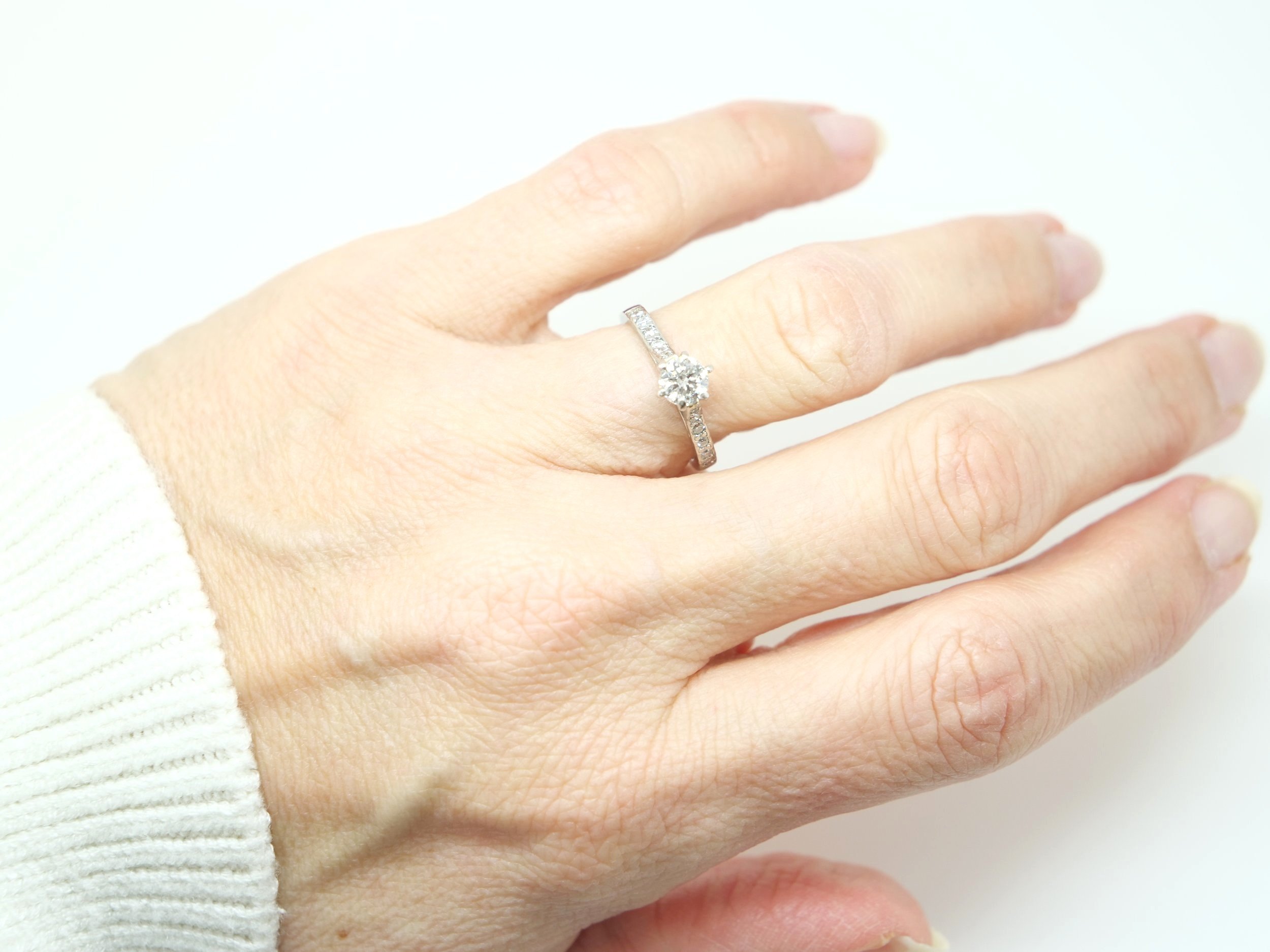 Super platinum gold diamond solitaire ring, set with a central brilliant cut diamond of approximately 0.55cts, with further brilliant cut diamonds set into each shoulder.