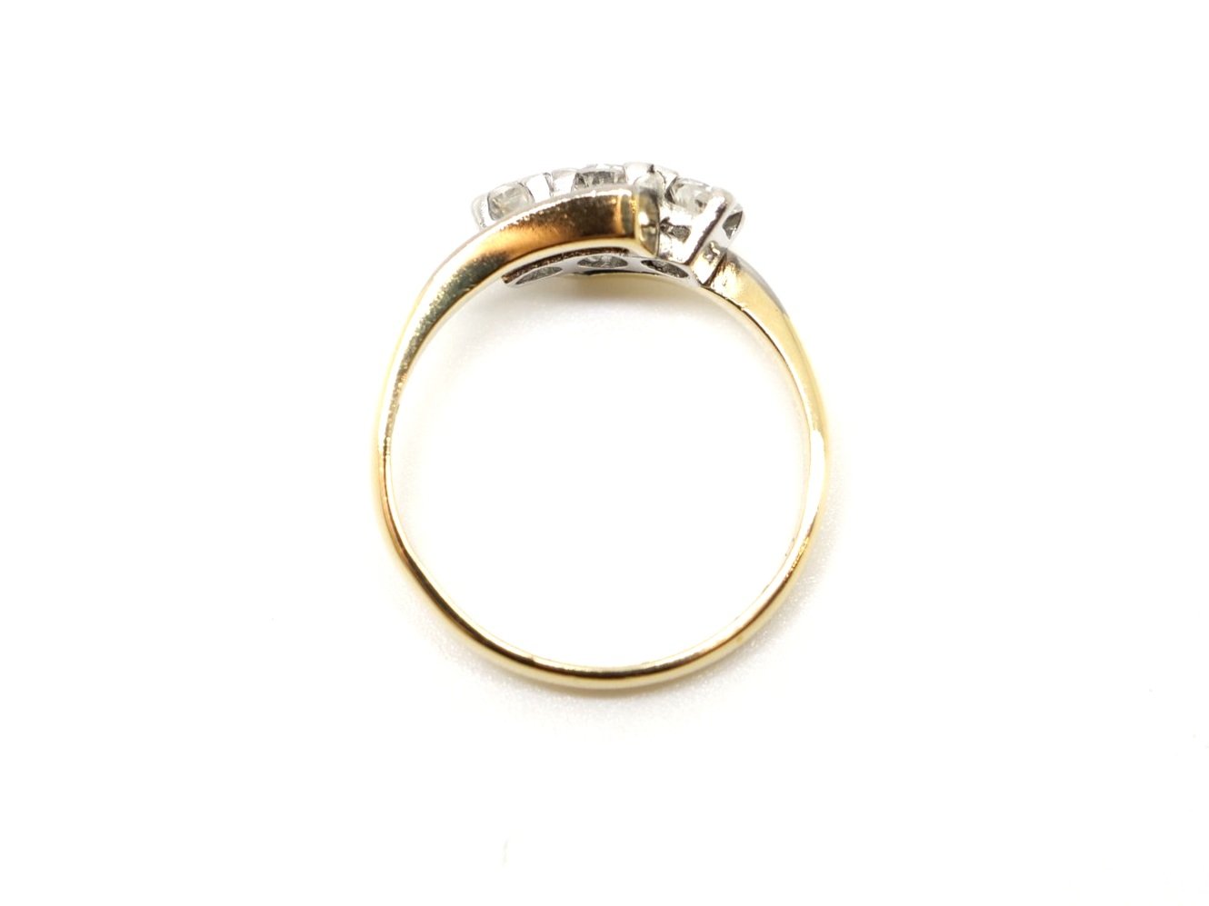 Very pretty Art Deco 18ct and Platinum diamond ring, set with three diamonds in this twist design so typical of the period.