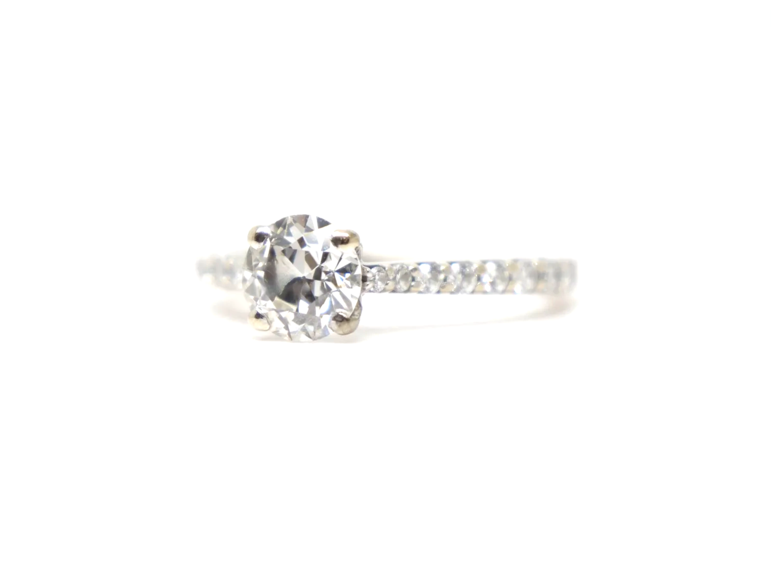 An 18ct gold old cut diamond solitaire with diamond-set shoulders
