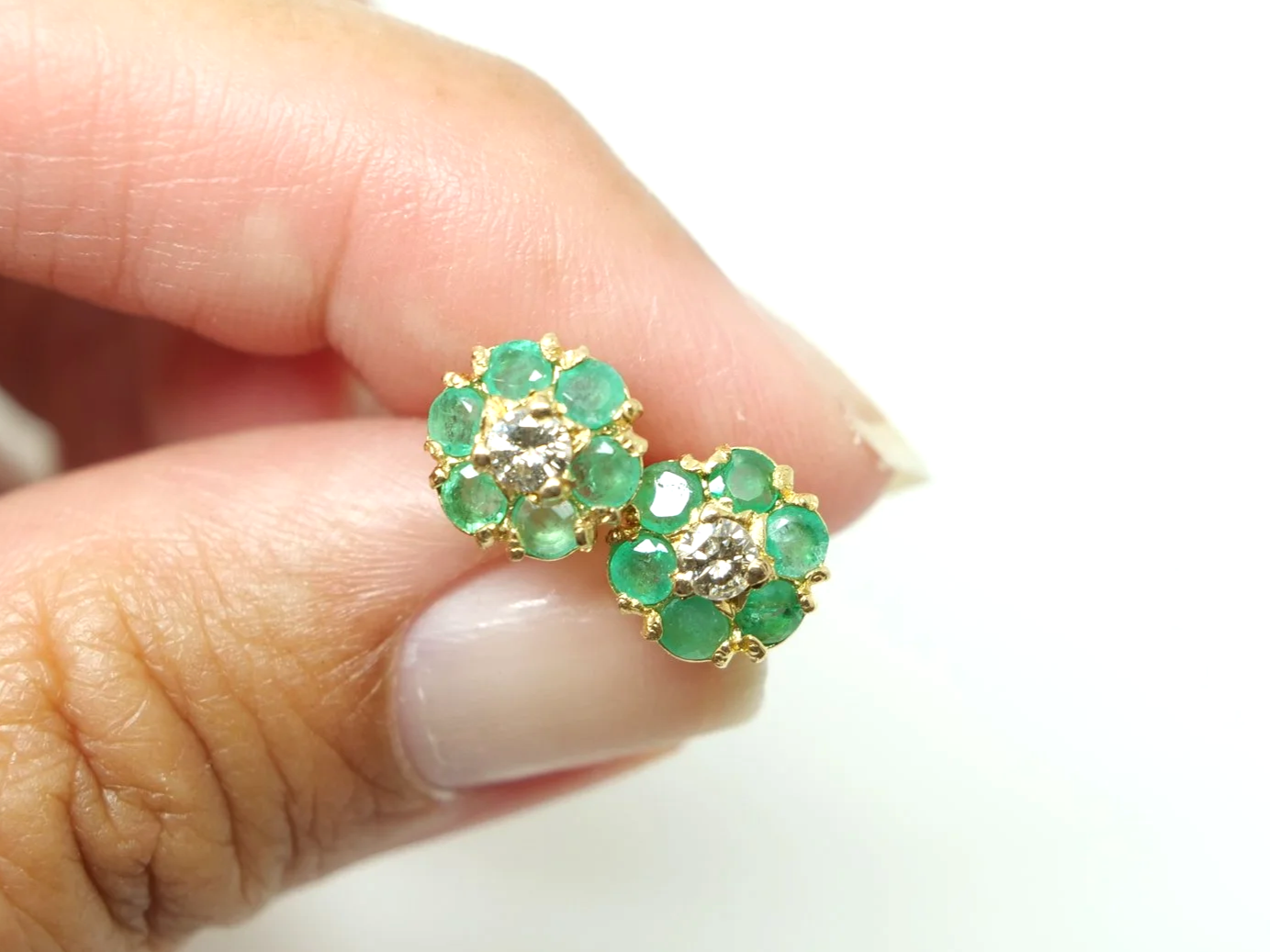 pretty pair of emerald and diamond daisy design vintage earrings in 9ct yellow gold, dating from 1975