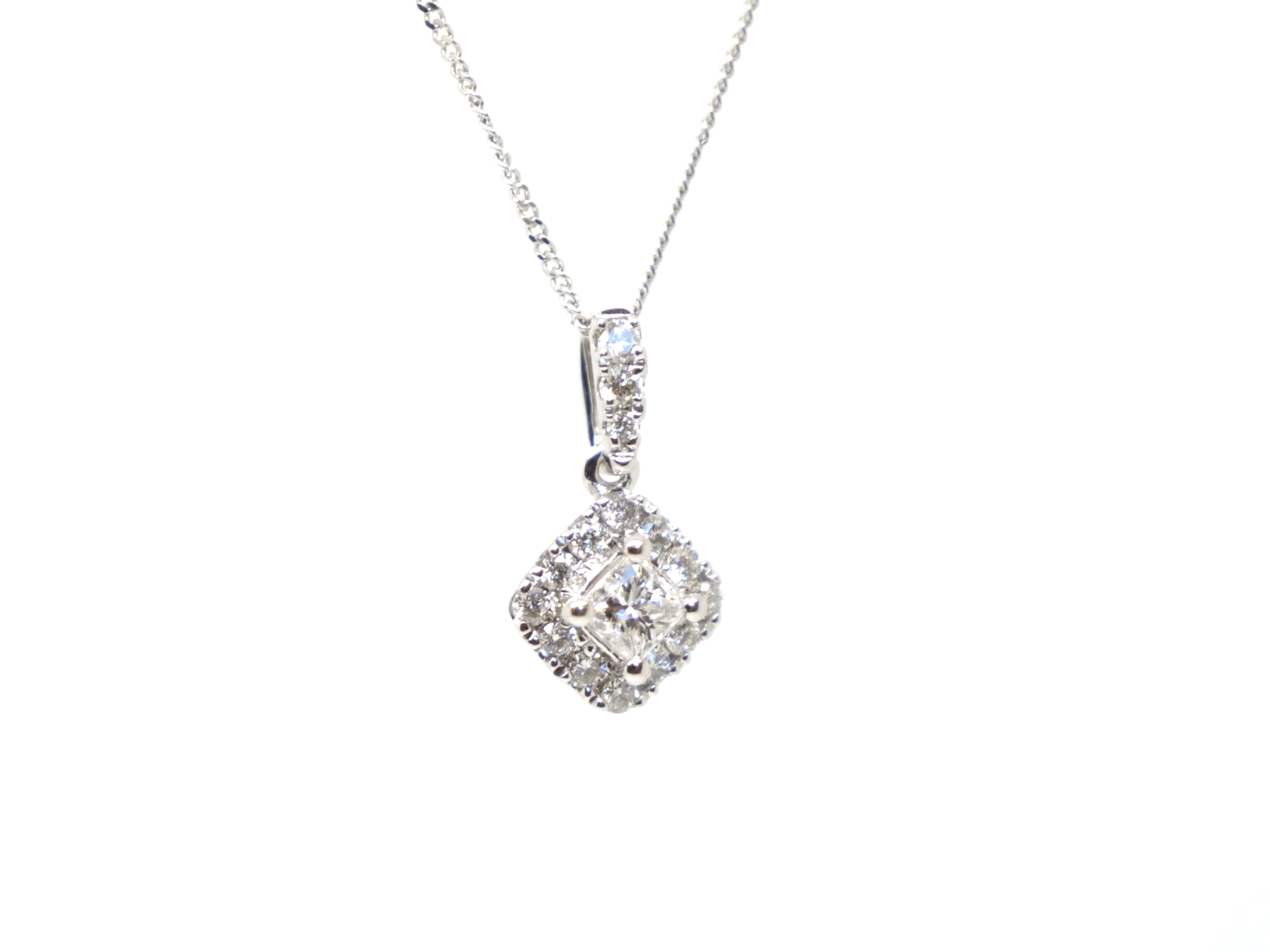Very pretty 9ct white gold pendant set with a central princess cut diamond, framed by a cluster of brilliant cut diamonds to form a soft diamond shape.