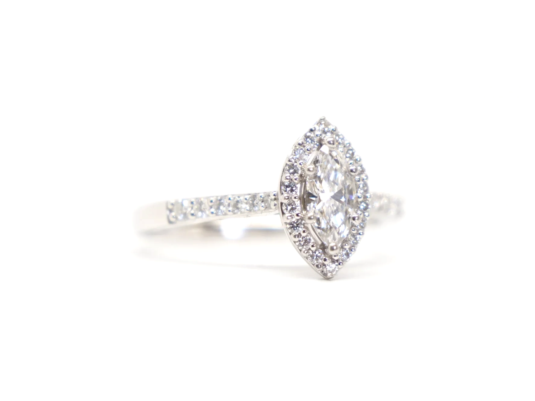 platinum diamond halo ring set with a marquise-cut diamond at the centre, surrounded by a pavé-set halo