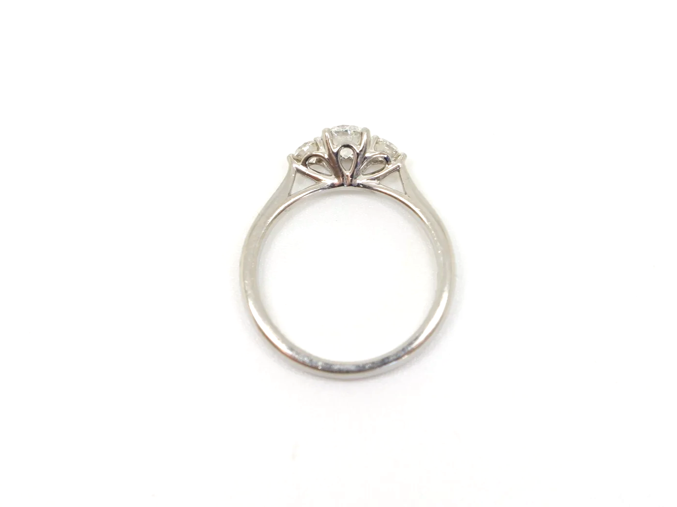 Platinum three stone diamond ring, central diamond flanked by two round diamonds