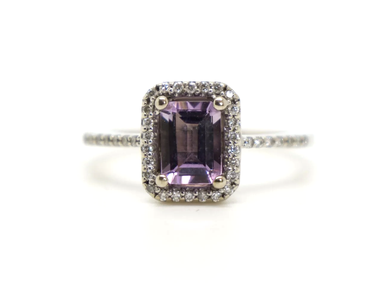 Contemporary design 9ct gold amethyst and diamond ring, set with an emerald cut amethyst and surrounded by diamonds. Further diamonds to each shoulder.