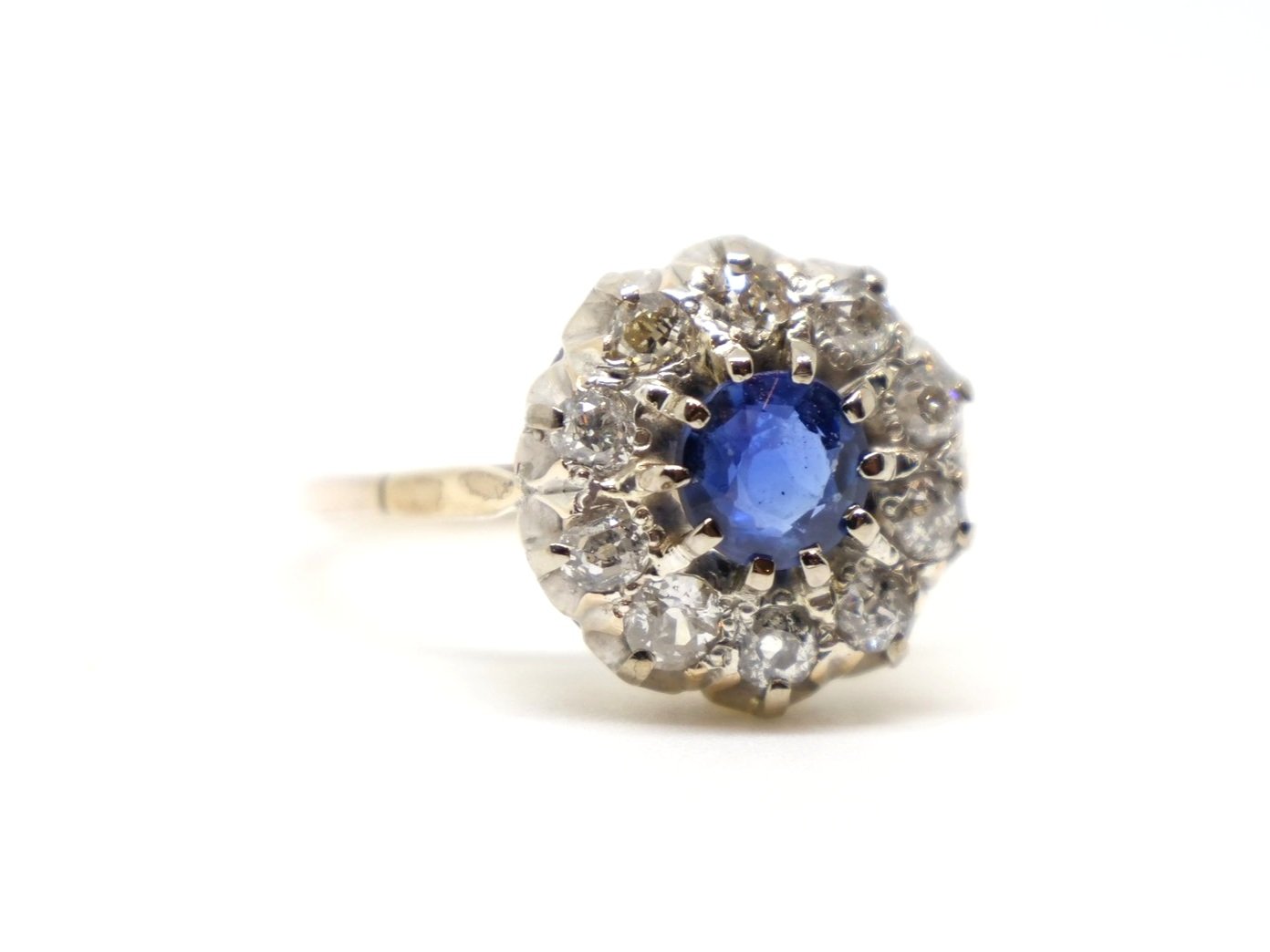 Super vintage sapphire and diamond ring, set with a mid blue round cut sapphire and surrounded by old cut diamonds.