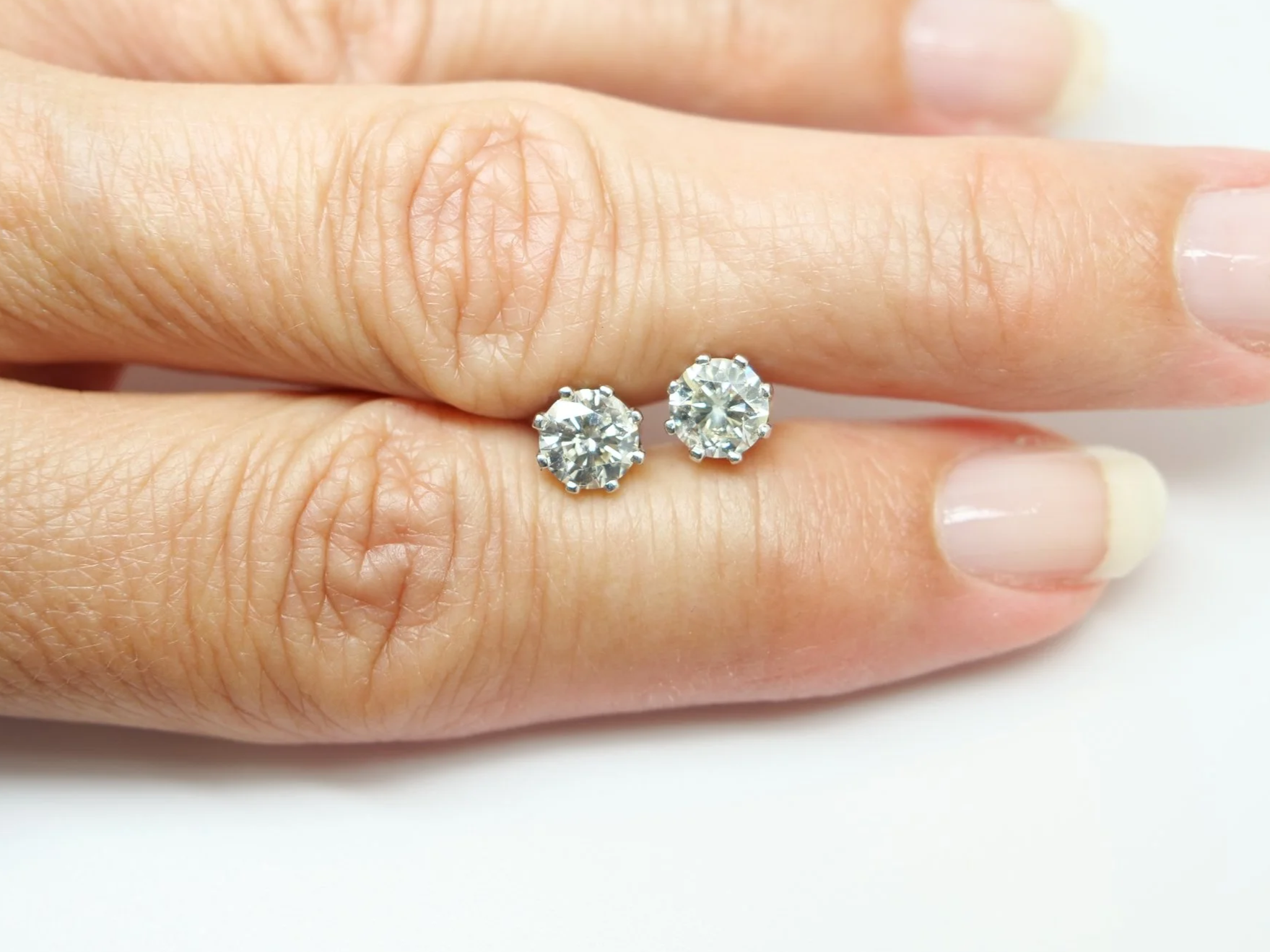 Lovely pair of 18ct white gold diamond stud earrings, each set with a round brilliant cut diamond of approximately 0.85 carats.