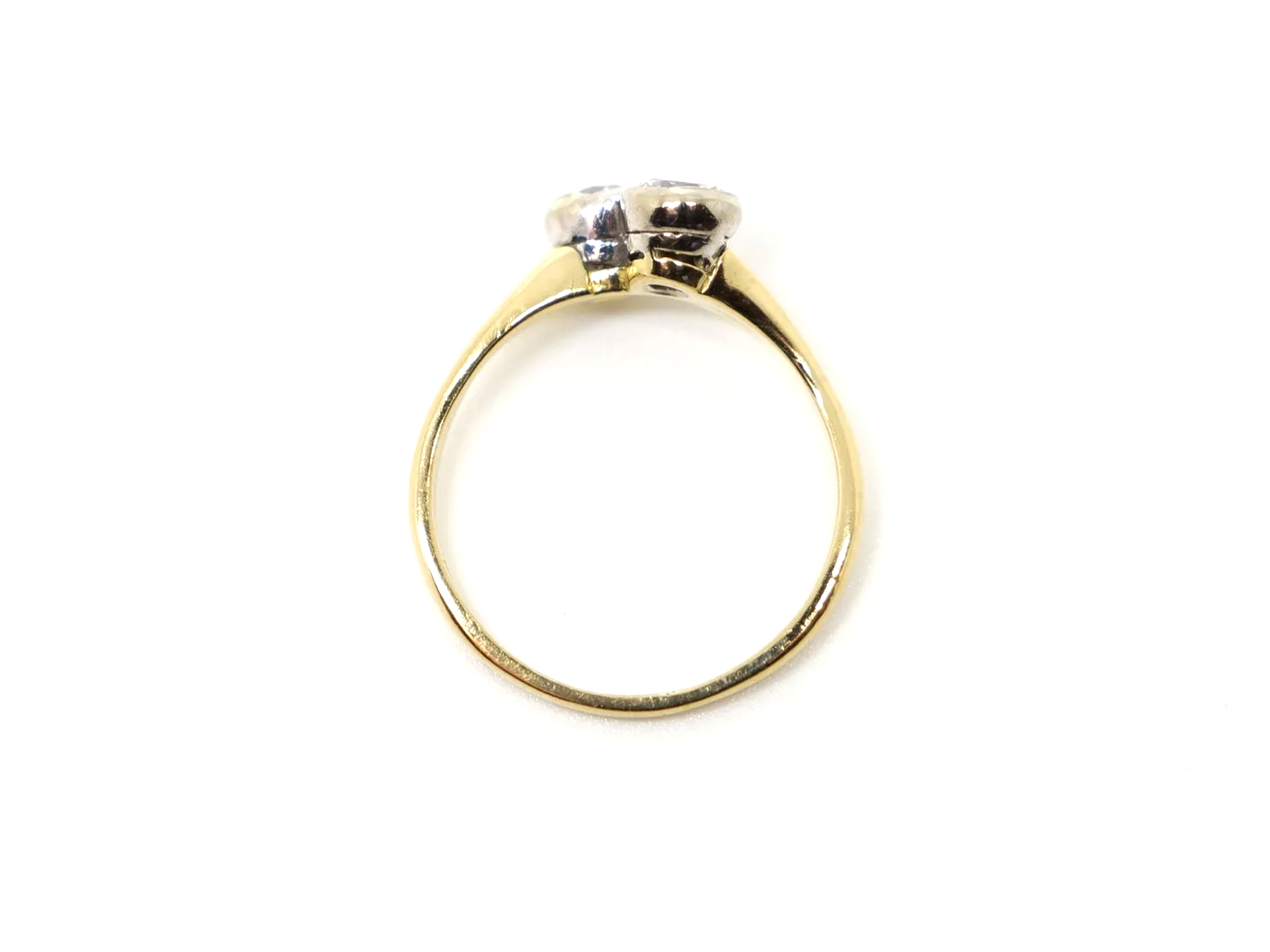 A vintage take on an old Art Deco design, this lovely quality 18ct gold ring is set with two brilliant cut diamonds in this more contemporary toi et moi.