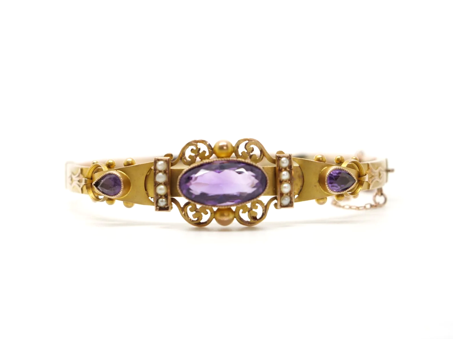 Beautiful Victorian style 9ct gold amethyst and seed pearl bangle, set with a lovely oval cut central amethyst with a pear cut amethyst to each side.