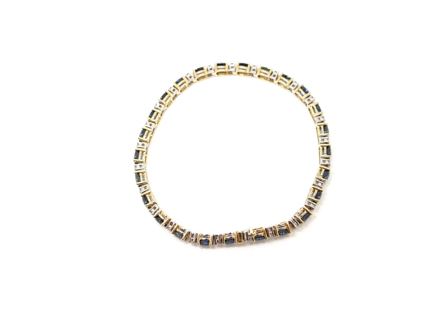 Super 14ct gold sapphire and diamond bracelet, set with lively oval cut blue sapphires interset with small diamonds. Clip over safety catch to keep secure.