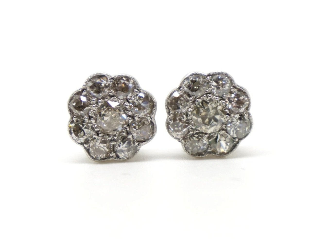 Beautiful 18ct gold old cut diamond earrings in a flower / daisy design, each set with nine old cut diamonds. With 18ct gold butterfly backs.
