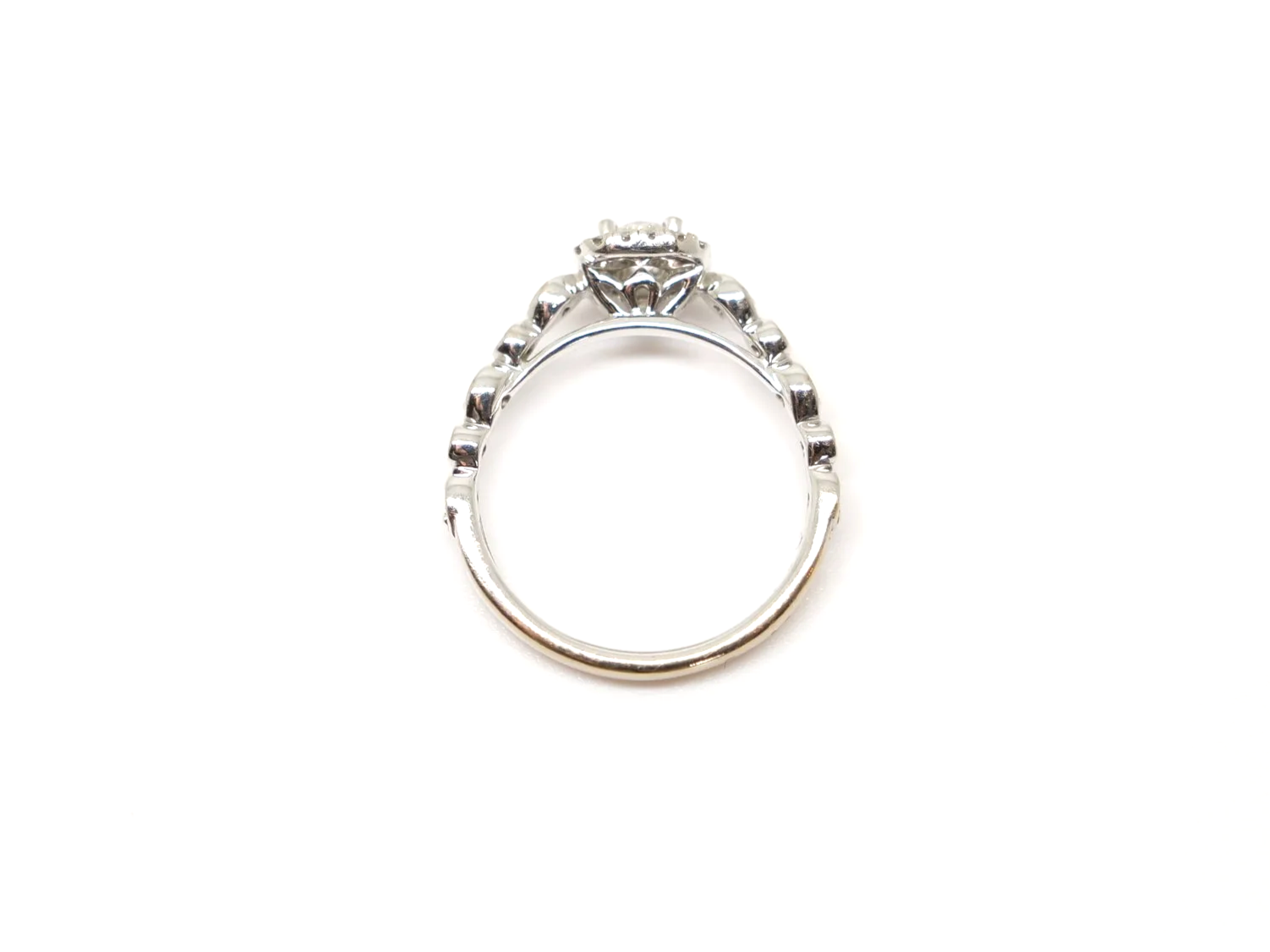 A platinum diamond halo ring by Emmy London, set with a round brilliant cut diamond at the centre surrounded by a cushion-shaped halo of smaller diamonds