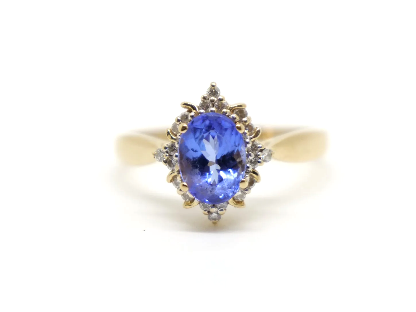 Very pretty 18ct gold tanzanite and diamond cocktail ring, set with a vibrant oval cut tanzanite and surrounded by brilliant cut diamonds.