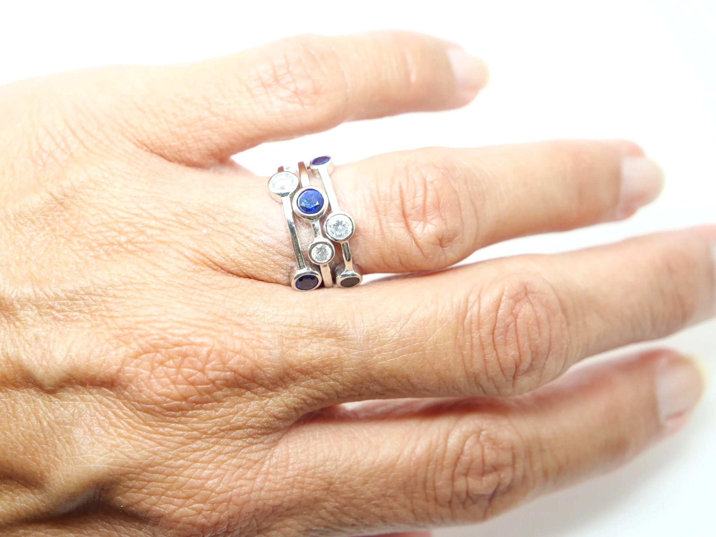 Beautiful platinum sapphire and diamond ring, often called a bubble ring and designed in the style of Boodles Raindance collection. Set with four sapphires and three diamonds.