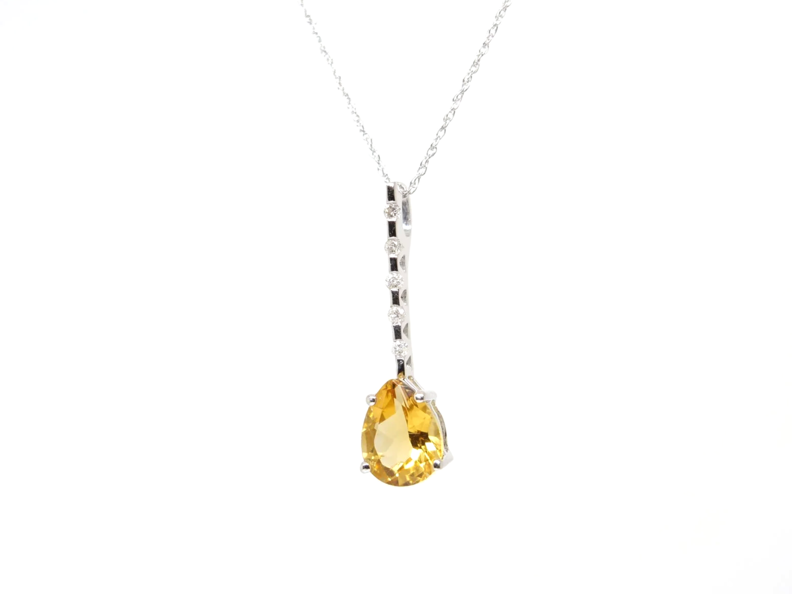 A 9ct white gold citrine and diamond pendant