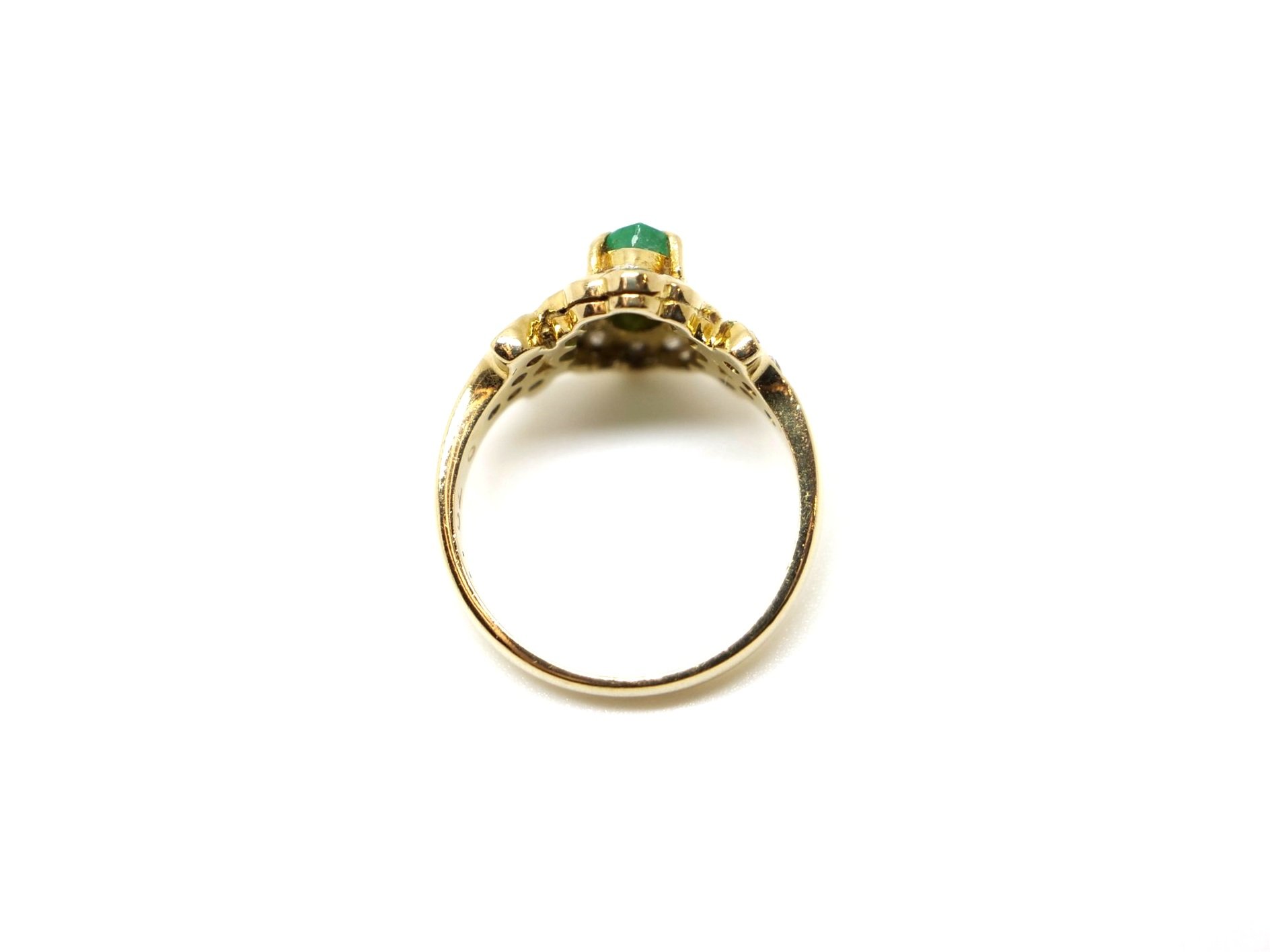 Very unusual 18ct gold emerald and diamond ring, set with a marquise cut central emerald and surrounded by diamonds. Further diamonds to each shoulder.
