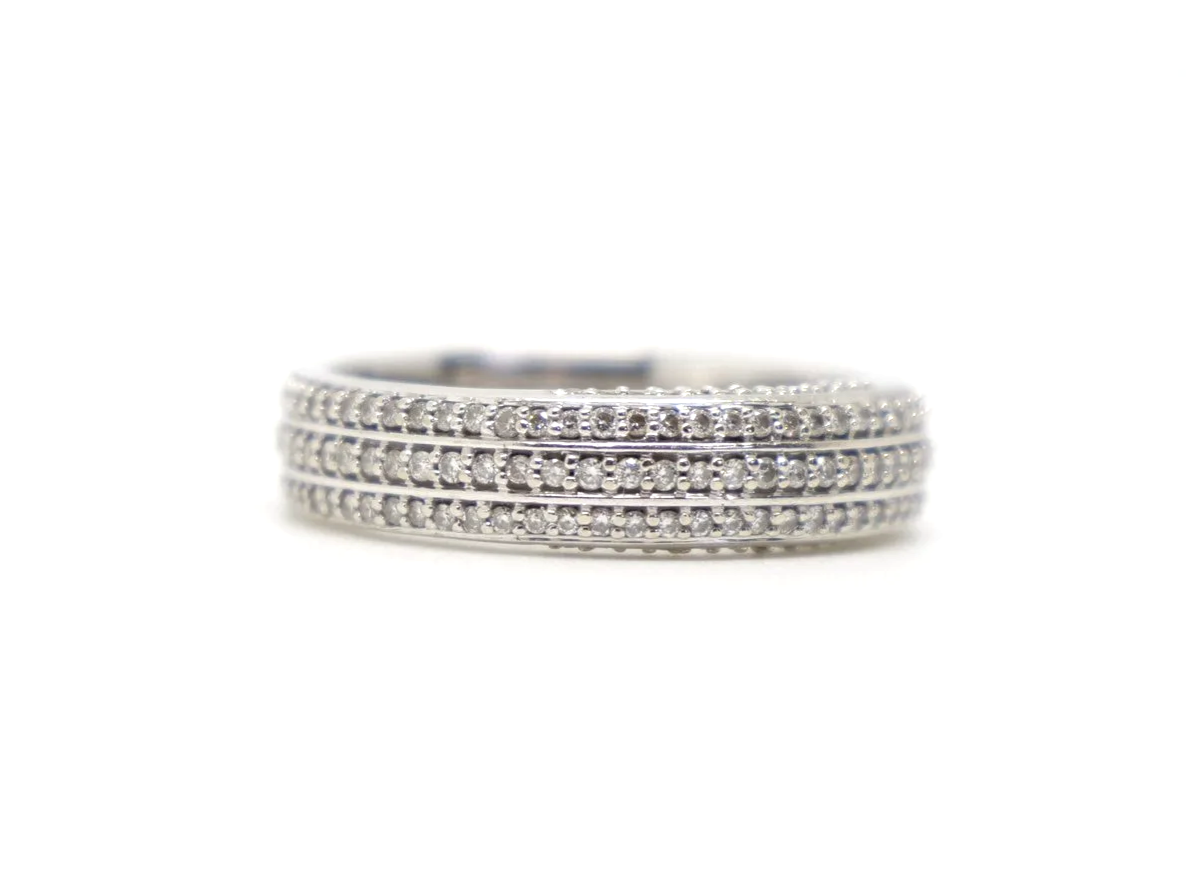 Contemporary 18ct gold triple row diamond three quarter eternity ring, with three rows of diamonds and further diamonds in both top and bottom of setting.