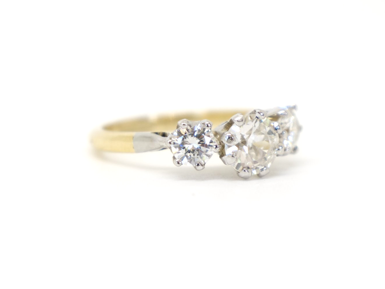 Very bright and sparkly 18ct gold diamond three stone ring, set with a central brilliant cut diamond of approximately 0.68cts. Further diamond to each side, with a total of approximately 1.24ct.