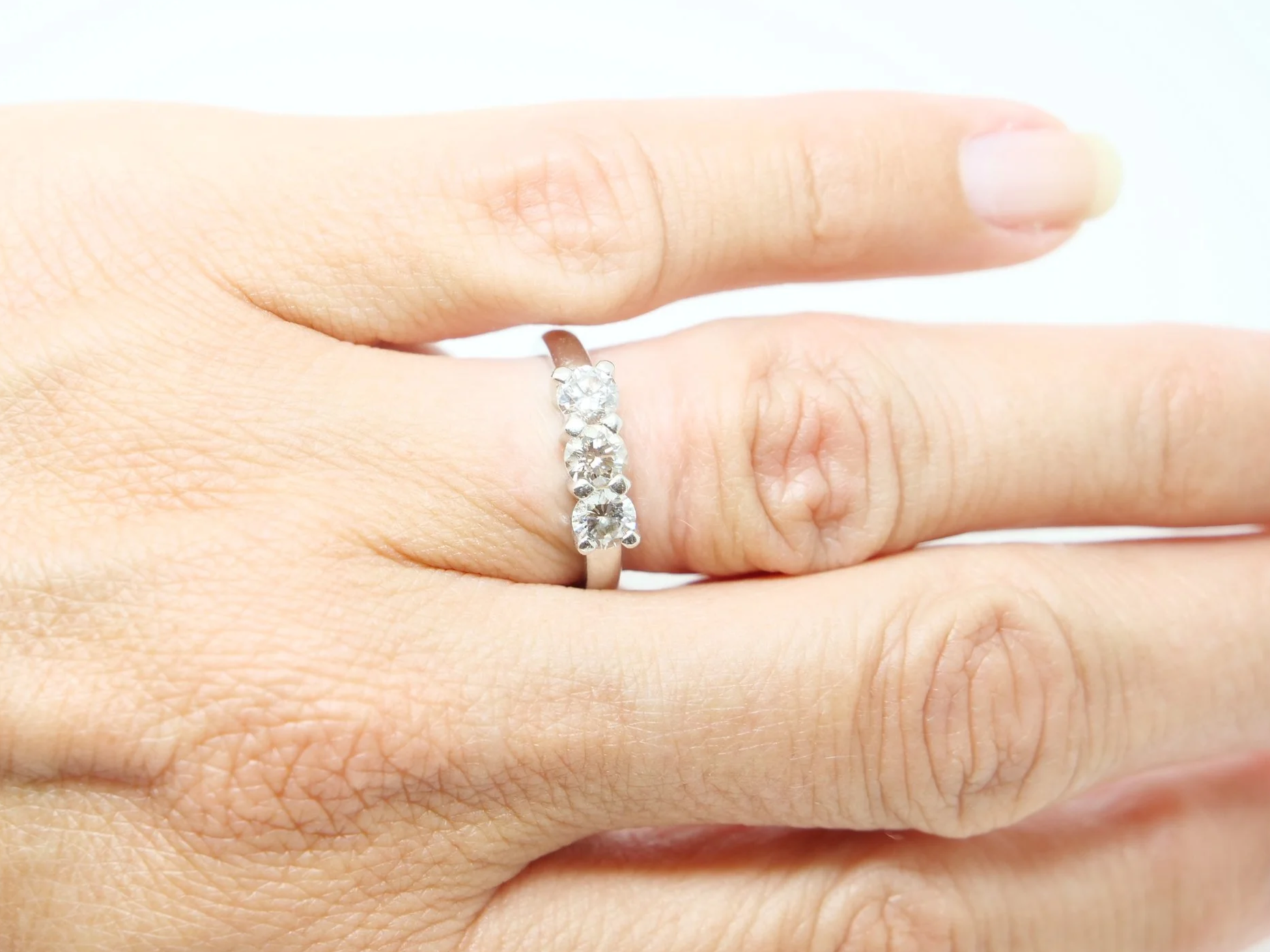 Platinum three stone 1ct diamond ring, three round brilliant cut diamonds in claw settings, hallmarked 2005, UK size K½