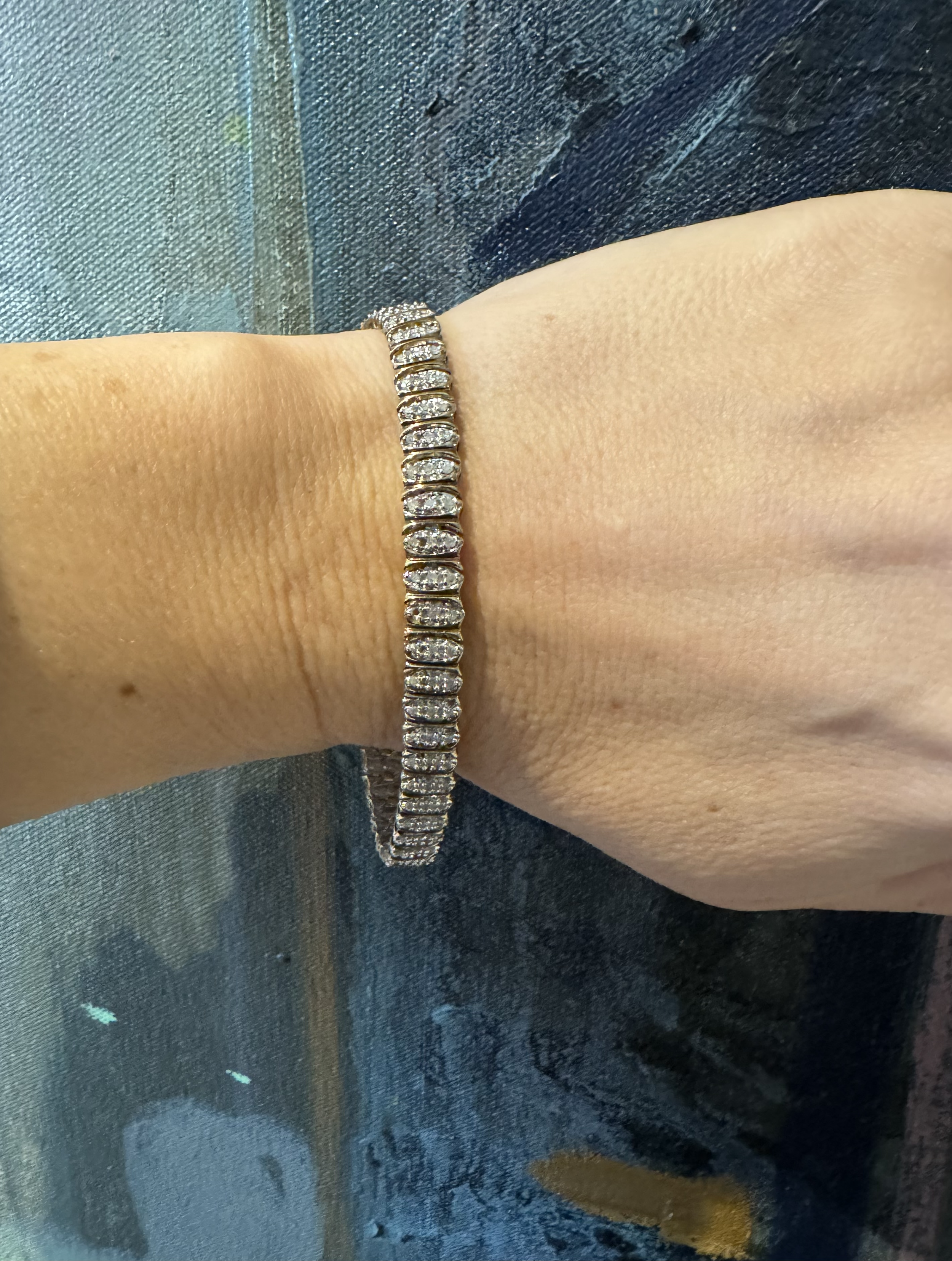 Lovely vintage diamond tennis bracelet, set with three small diamonds in each link. Total of approximately 1ct diamond weight.