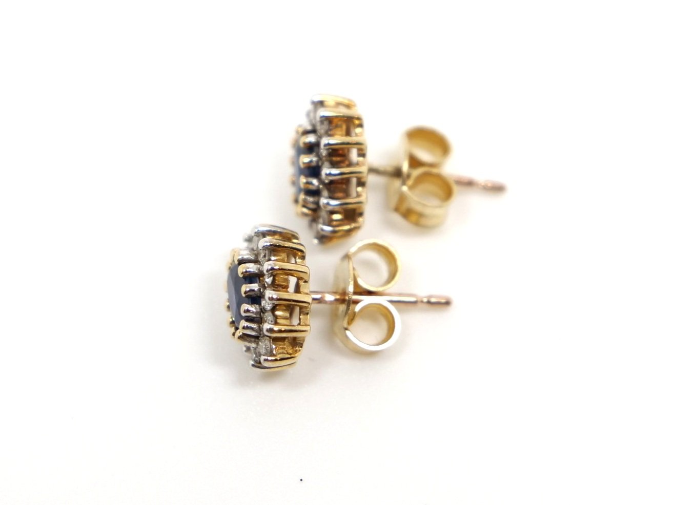 Pretty 9ct gold sapphire and diamond cluster earrings, each set with an oval cut sapphire and surrounded by diamonds.
