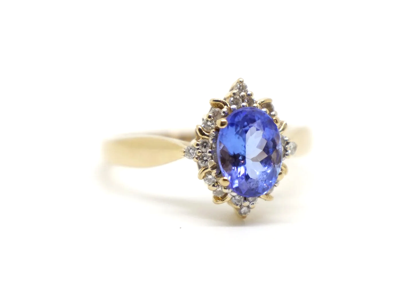 Very pretty 18ct gold tanzanite and diamond cocktail ring, set with a vibrant oval cut tanzanite and surrounded by brilliant cut diamonds.
